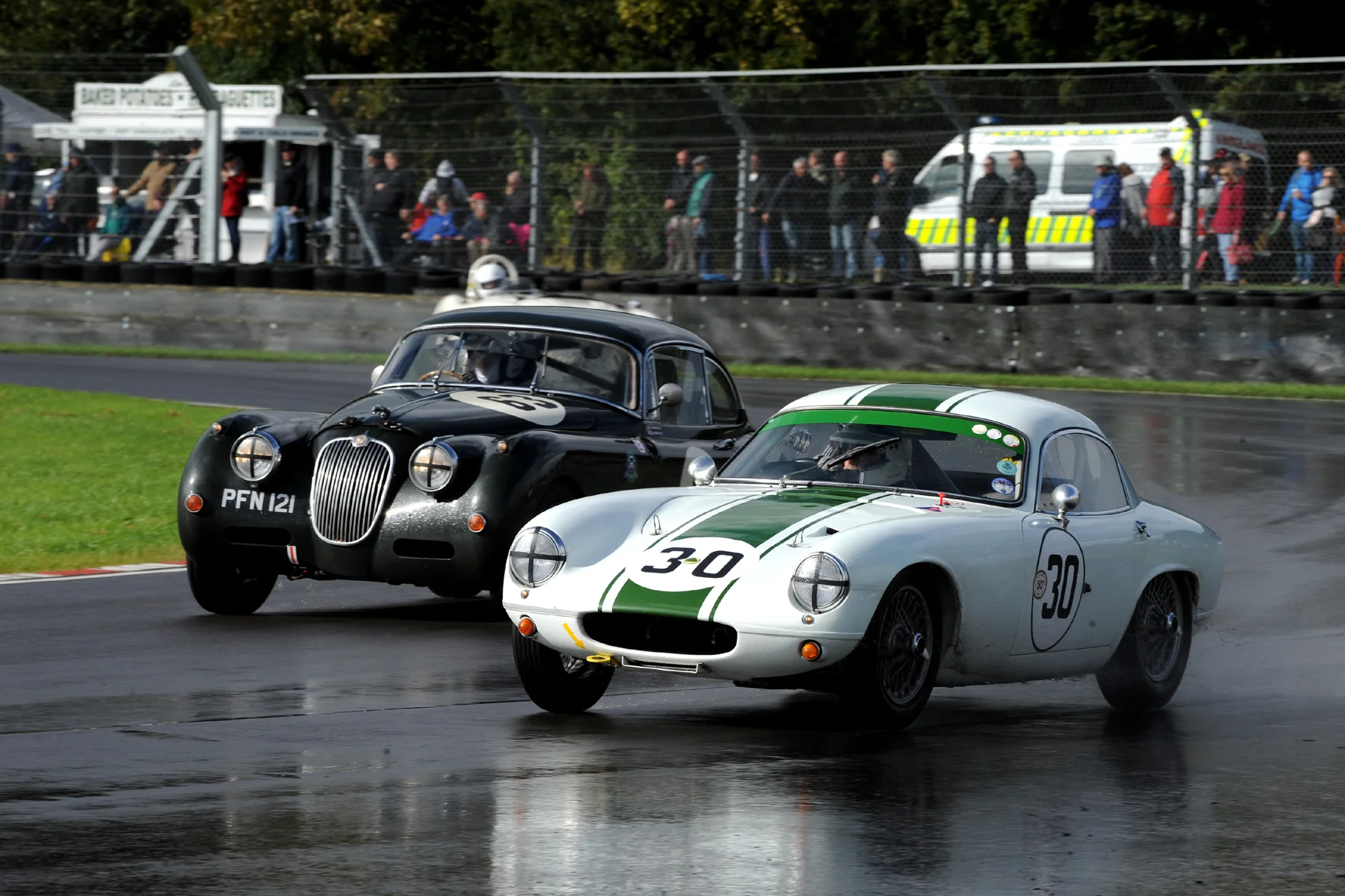 Barry Dye in his Lotus Elite about to be lapped by Graham Love in his Jaguar XK150 Photo - Jeff Bloxham