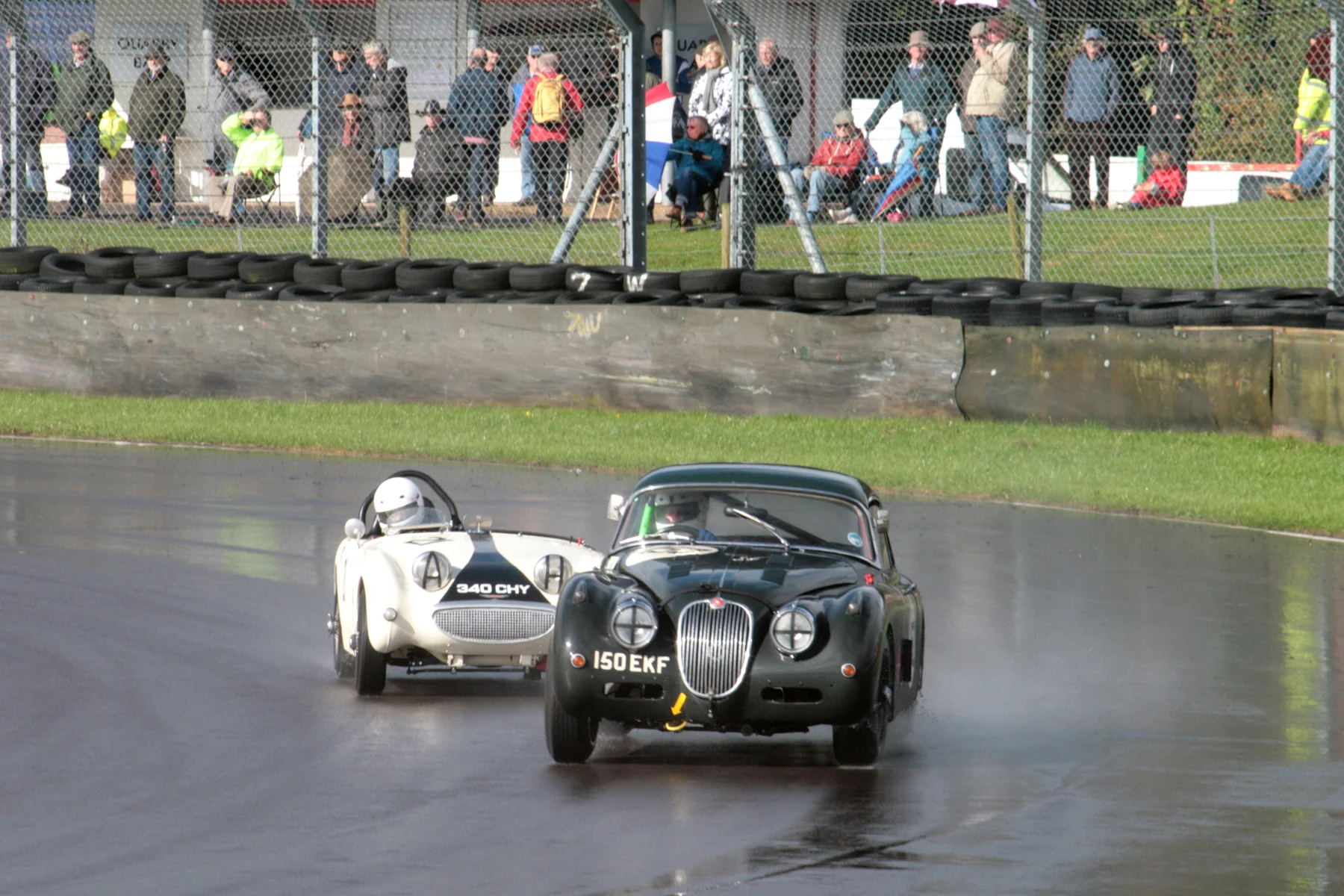 Claire Keith-Lucas in her Jaguar XK150 and Neil Cameron. Note all the spectators braving the elements. Photo - John Turner