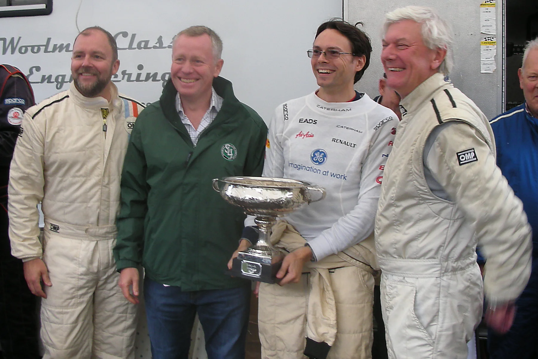 Jonathan Abecassis, as a member of the Healey Hounds team, holds the Inter-Marque Trophy with fellow team members , Jason Harris (left) and Nick Matthews (right). Photo - Pat Arculus, Tripos Media