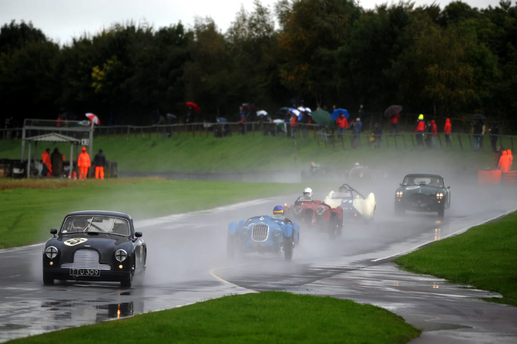 But behind Steve, a delightful group of cars crossed the line for the first time _ Nick Ruddell (DB2/4), Sam Stretton (Alta Sports), Mark Gillies (Aston Monoposto), Brian Arculus (Lotus IX) and Chris Woodgate (DB MkIII). Barely visible is Chris Mann, according to the lap charts aleady 6 seconds behind being pushed hard by Simon Diffey in the Aston Ulster. Photo - Jeff Bloxham