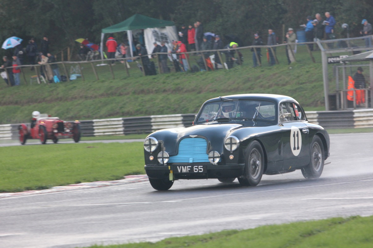 Another fantastic and historic Aston. The famous ex works DB2 , owned by Justin Kennedy, and driven by Tony Green. In the background Edward Bradley pursues in the Ulster. Photo - Pat Arculus, Tripos Media
