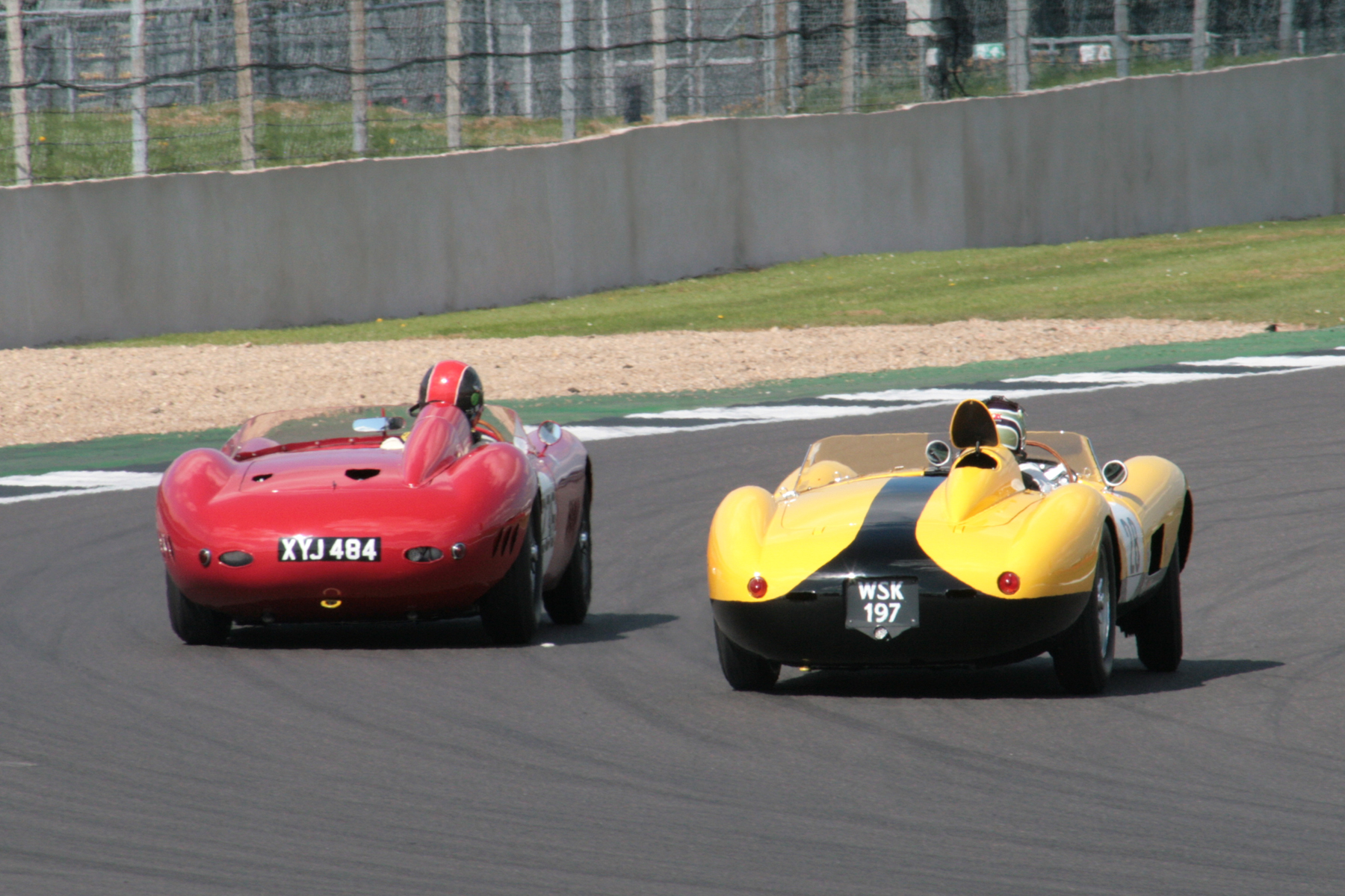 Recalling halcyon days! The Ferrari gets up the inside of the Maserati at Woodcote but giving away a litre was usually behind at the end of the straights. Note the fuel filler flap which had popped up when James spun the Ferrari into Brooklands whilst in the lead. Photo John Turner