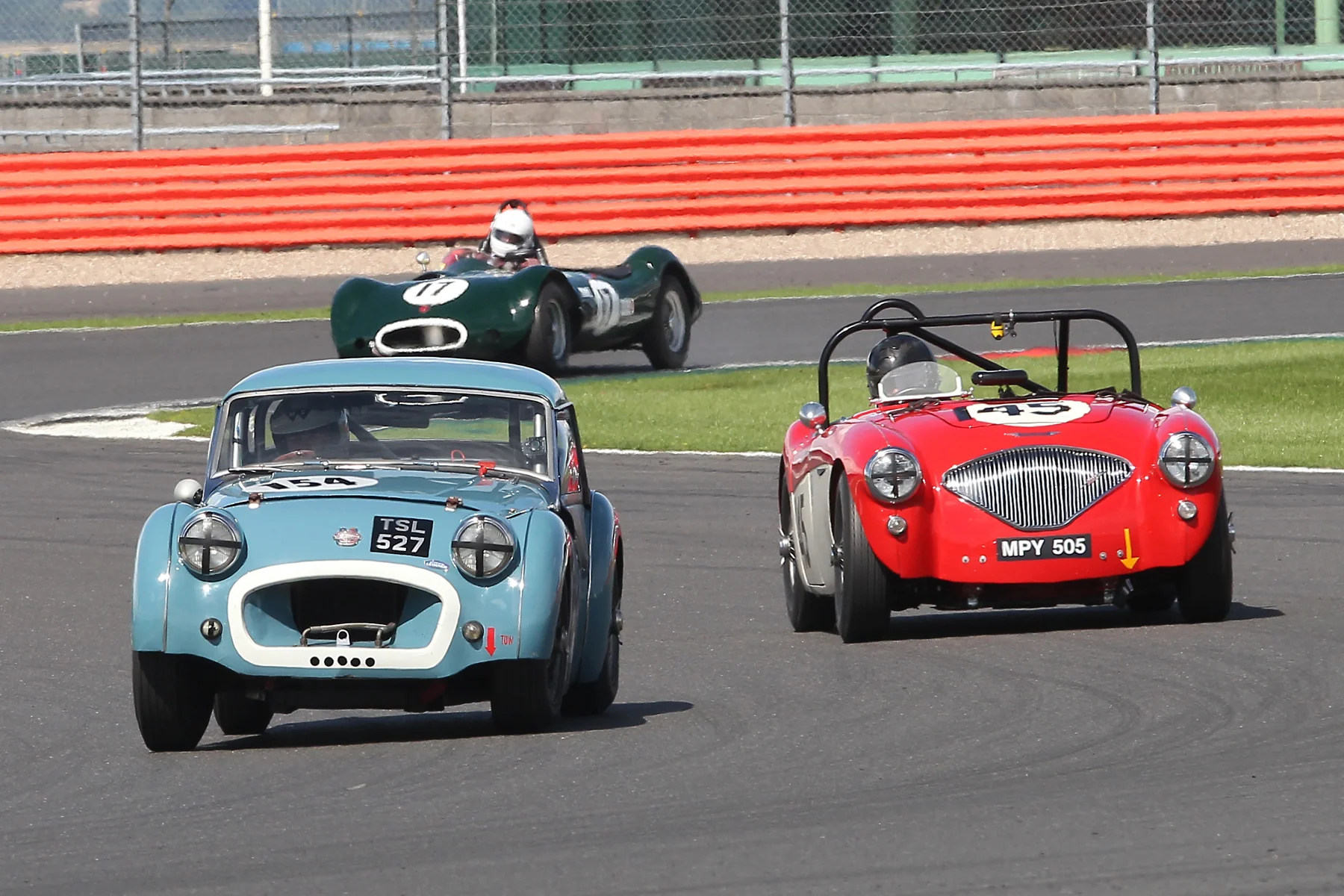 Paul Ziller made a good start getting his TR2 ahead of both Paul Mortimer in the Austin Healey (145) and Alex Quattlebaum in the LECo (11), although the Austin Healey's ultimate pace was 1.5 seconds a lap quicker than the TR which was to have its own drama, here, in Luffield a few laps later. Photo - Mick Walker