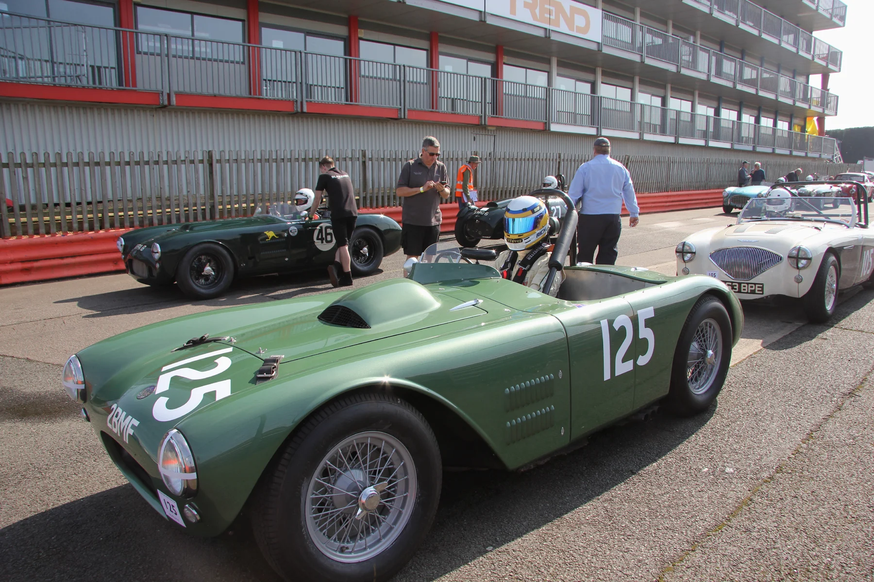 Richard Woolmer awaits the start of practice in Matthew Collings HWM Cadillac V8. Matthew is in the Austin Healey 100M lined up behind and at the head of the other queue is Martin Hunt's HWM Jaguar. Great to see two of 60+ year old products of Walton still gracing our tracks. Photo - Pat Arculus, Tripos Media