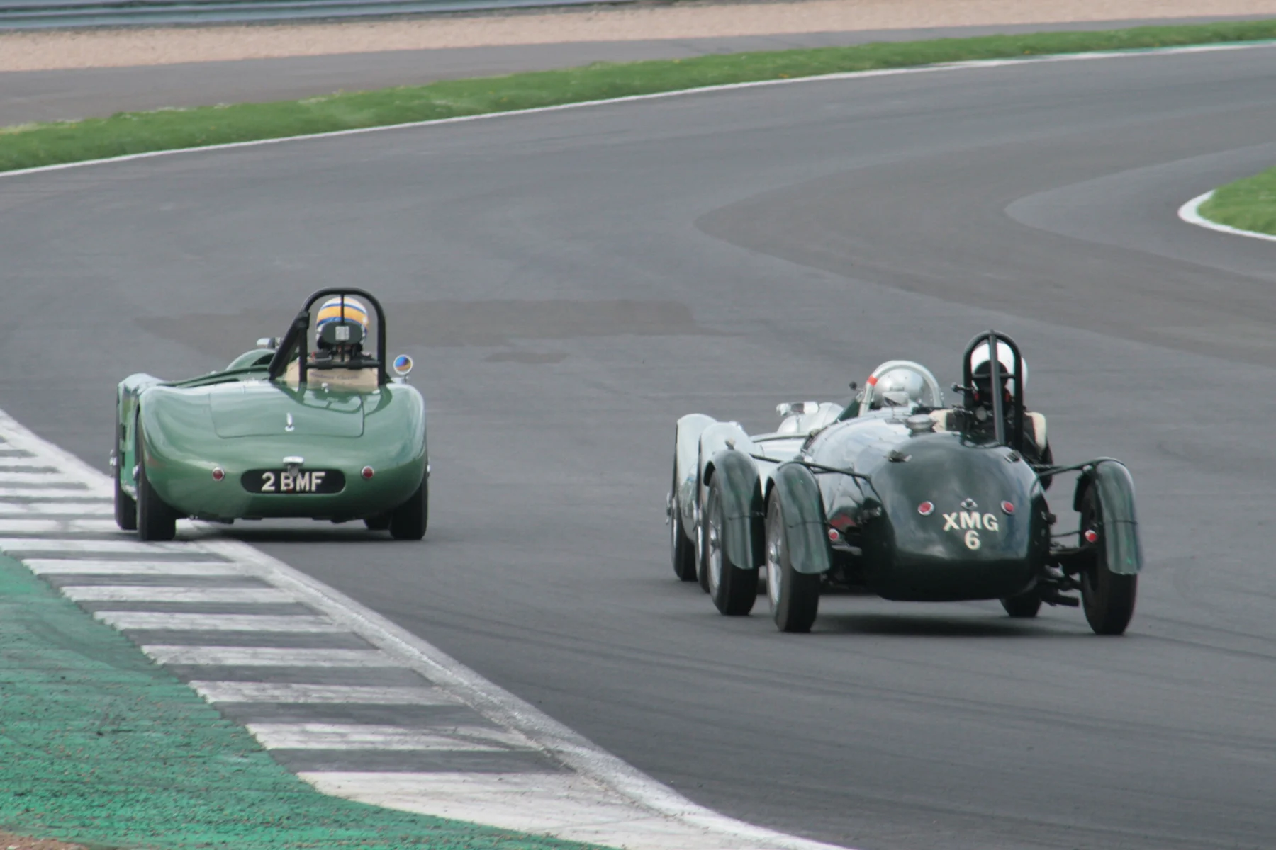 Stephen Bond (Lister Bristol), just visible and Martyn Corfield (Frazer Nash LMR) hound Richard Woolmer in the HWM Cadillac through Woodcote. This terrific scrap lasted for many laps Photo - John Turner