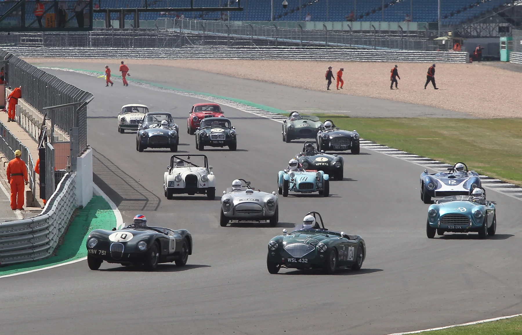 A wonderfully eclectic mix of 1950s sports cars get off the line as the marshals disperse to take up their positions Photo - Mick Walker