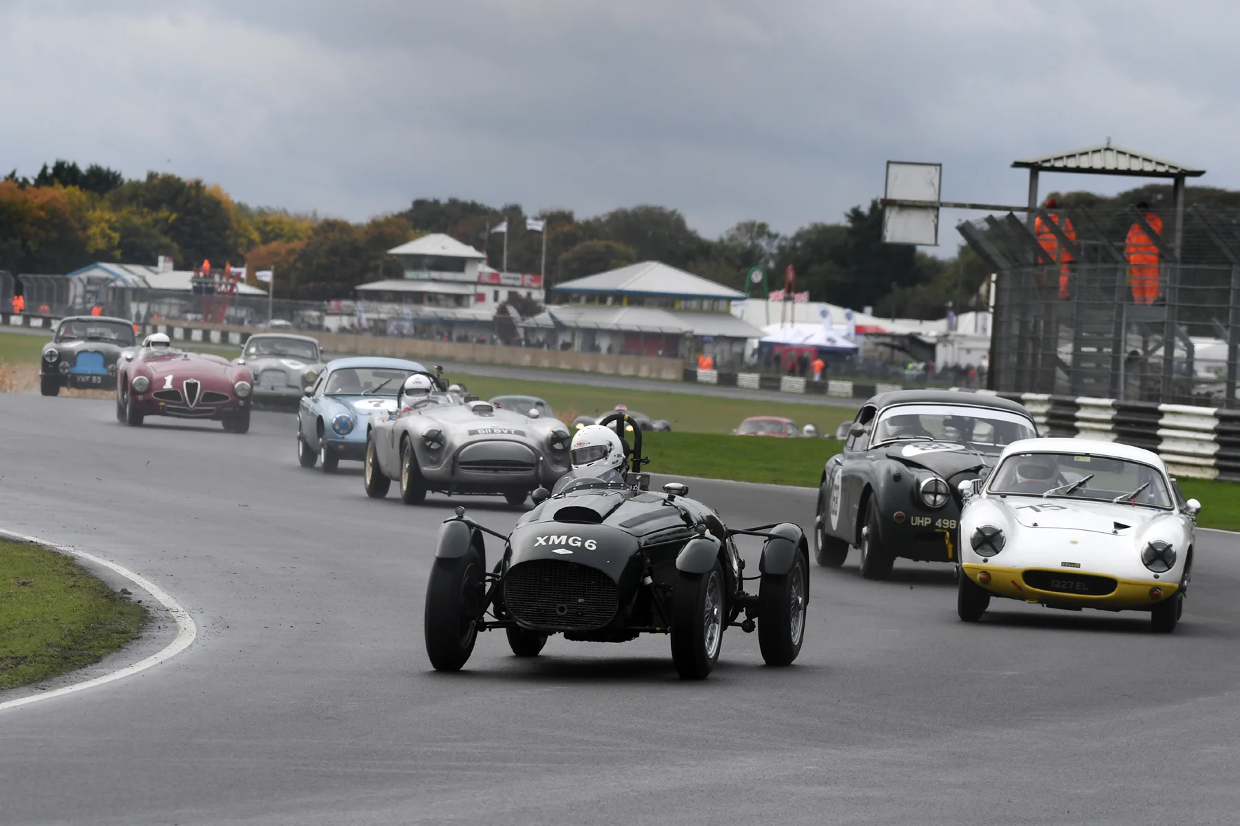 Superb start by Martyn Corfield in the FNLMR saw him head the field into Quarry, chased by Poleman, Robin Ellis (Lotus Elite) and Marc Gordon (Jaguar XK150) . Front row man, Andy Shepherd (AC Ace) is 4th, whilst Brian Arculus (Lotus Elite) and Chris Mann (Alfa Romeo Disco Volante) made good starts to be 5th and 6th respectively. Note however, cresting the rise in the Metallic grey Aston Martin is Tim Stamper up from 16th on the grid. Stephen Bond’s Lister Bristol is all but hidden behind the Alfa. Photo - Jeff Bloxham