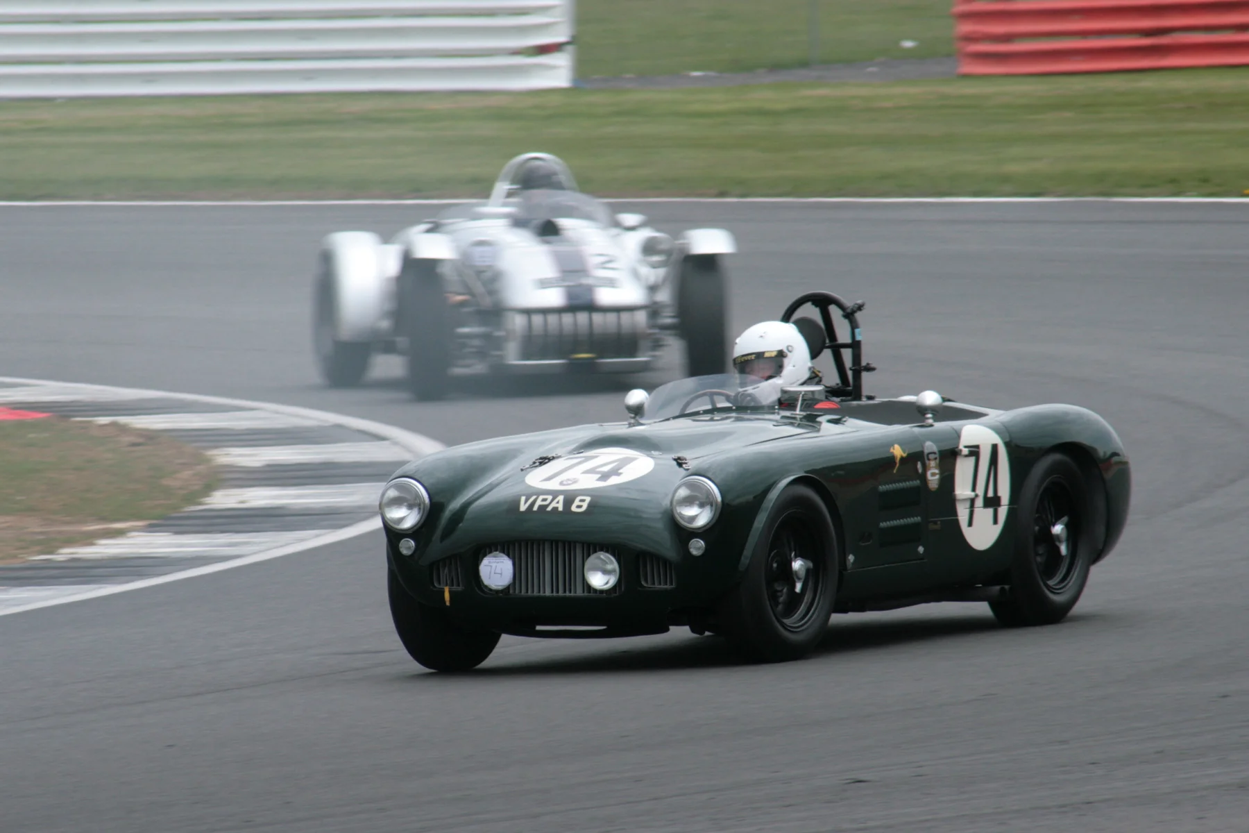 Martin Hunt in the HWM Jaguar had to work extremely hard to overcome the Kurtis 500S of Chris Keen. The Kurtis is partly obscured here by smoke trailing from the ailing Cooper Monaco of Andrew Smith which was soon to retire. Photo - John Turner