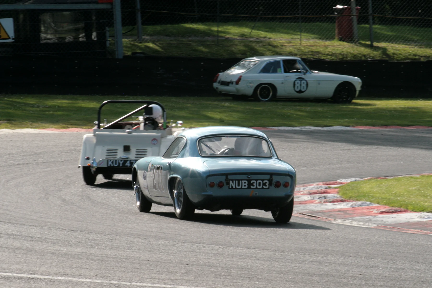 Druids, and Brian Arculus is about to lap Mark Shears. Note Harry Brown’s MGB GT parked up having retired on lap 6.