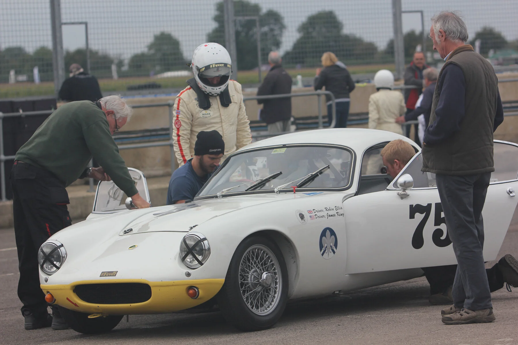 Much activity around the 4th place Lotus Elite. Robin Ellis already out of car, and Richard Fores getting strapped in Photo - Pat Arculus, Tripos Media