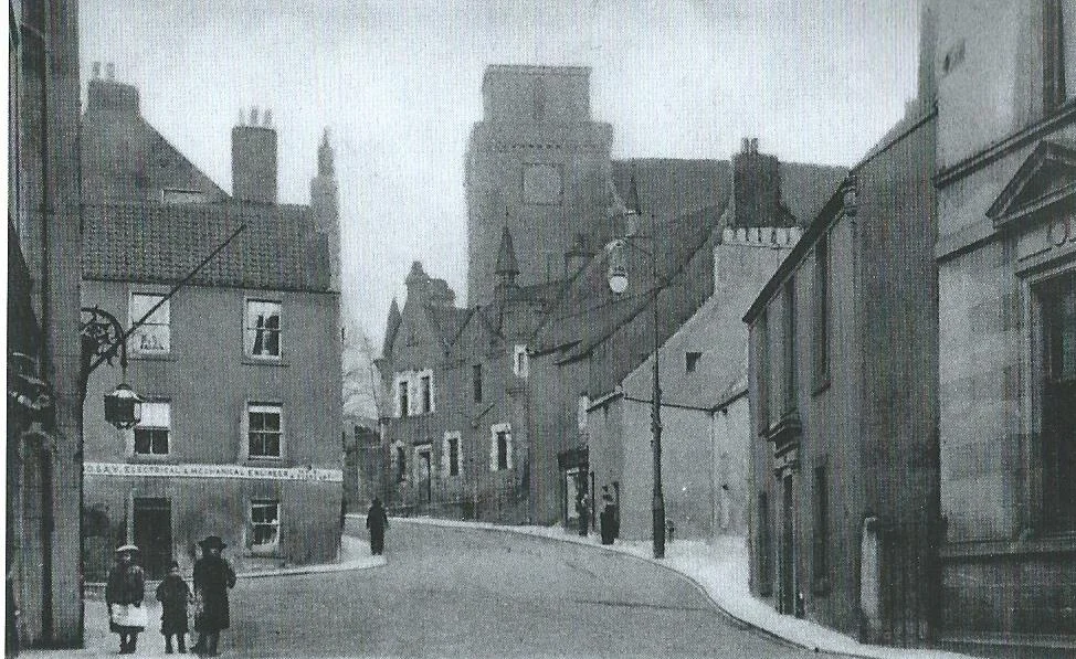 Old Kirk Wynd - Kirk means Church, Wynd means a narrow street or alley. The Kirk (Parish church) at the top of road was consecrated in 1244. The lighter coloured dwelling on the right-hand side was the home of the Myles family , no. 32
