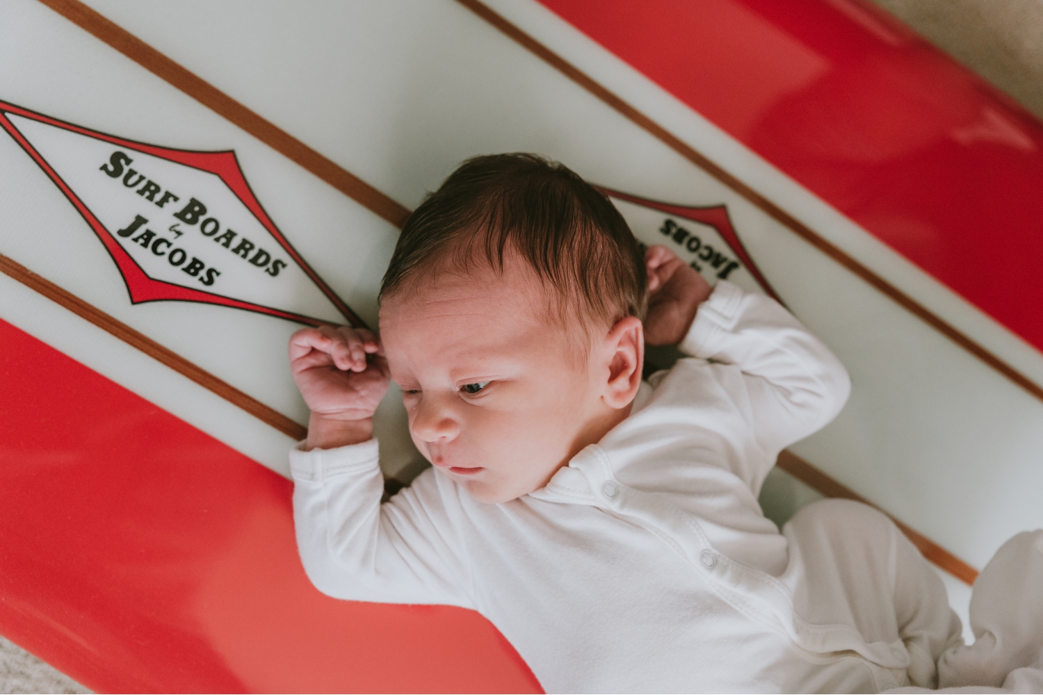 Picture-Of-Newborn-On-Custom-Surf-Board-During-Newborn-Photo-Session