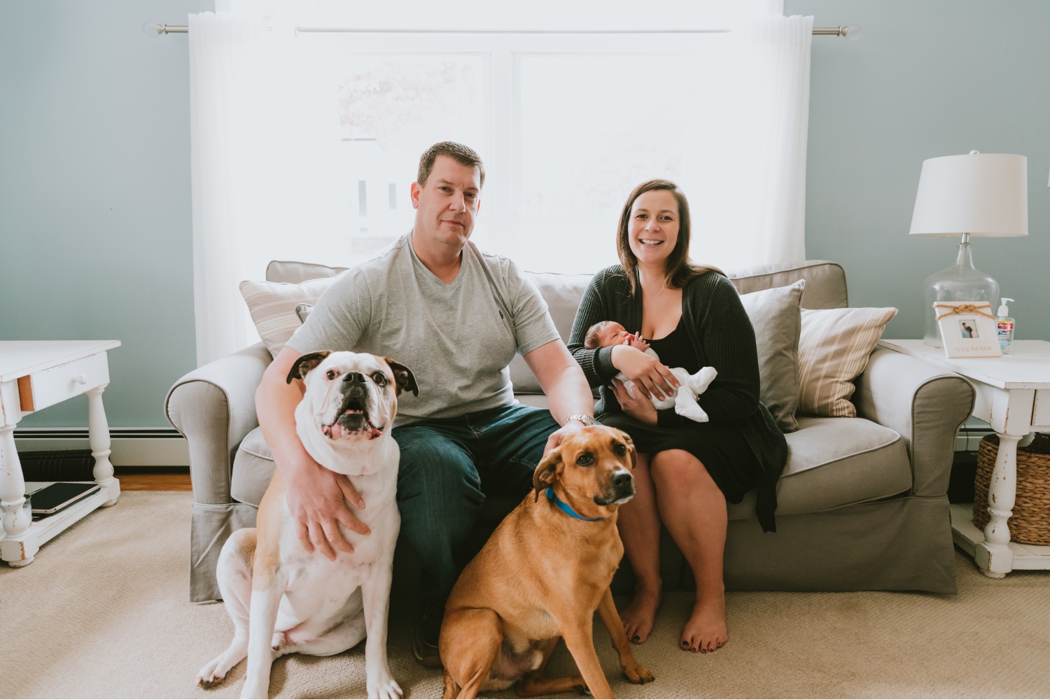 Picture-Of-Family-With-Dogs-And-Newborn-On-Couch-During-Newborn-Photography-Session-Ocean-County-New-Jersey