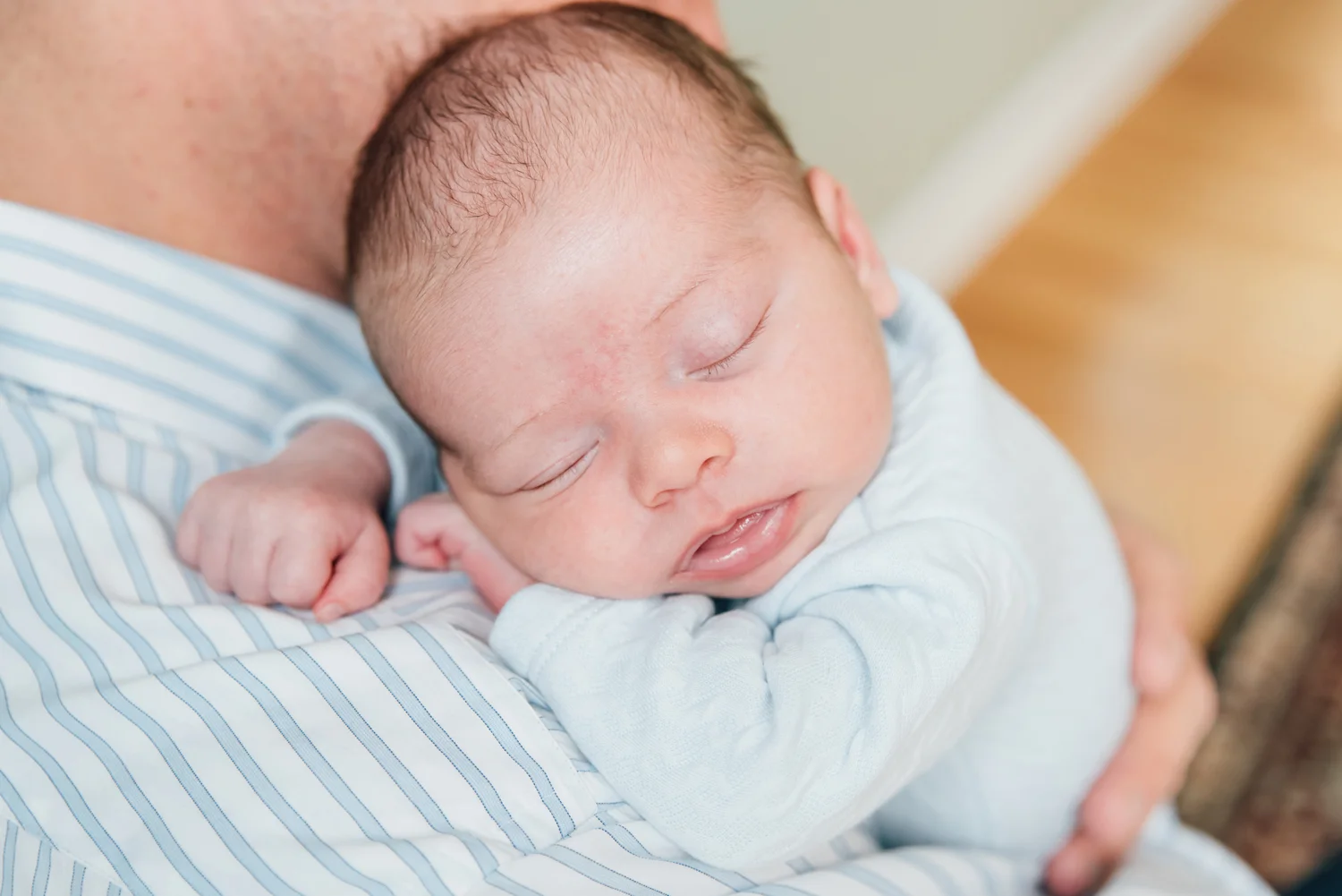 Newborn baby boy sleeping on daddy’s shoulder during newborn photography session in Brick, New Jersey. Michelle Amy Photography Monmouth County New Jersey Newborn Photographer.