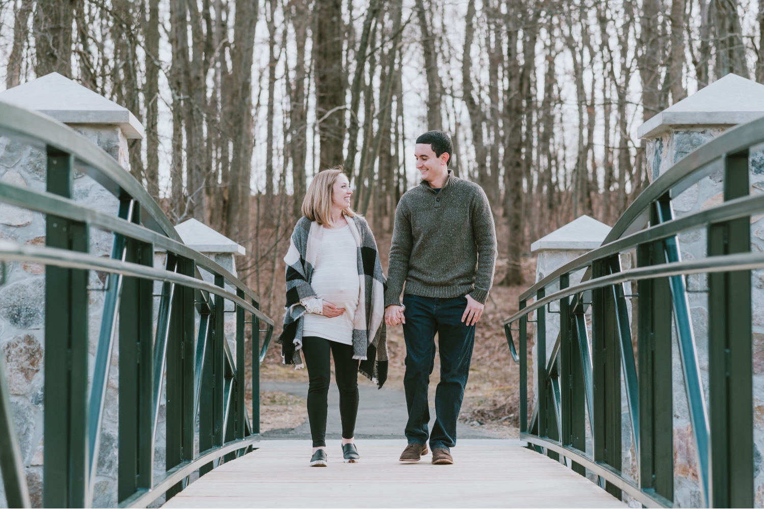Expecting Twin Parents Walking on Bridge in Morris County New Jersey