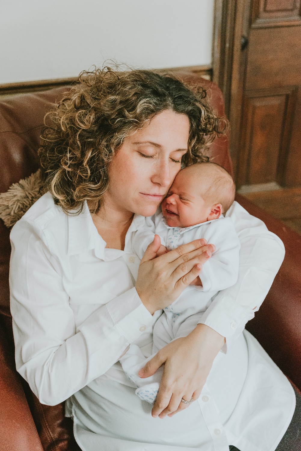 Smiling Newborn With Mother