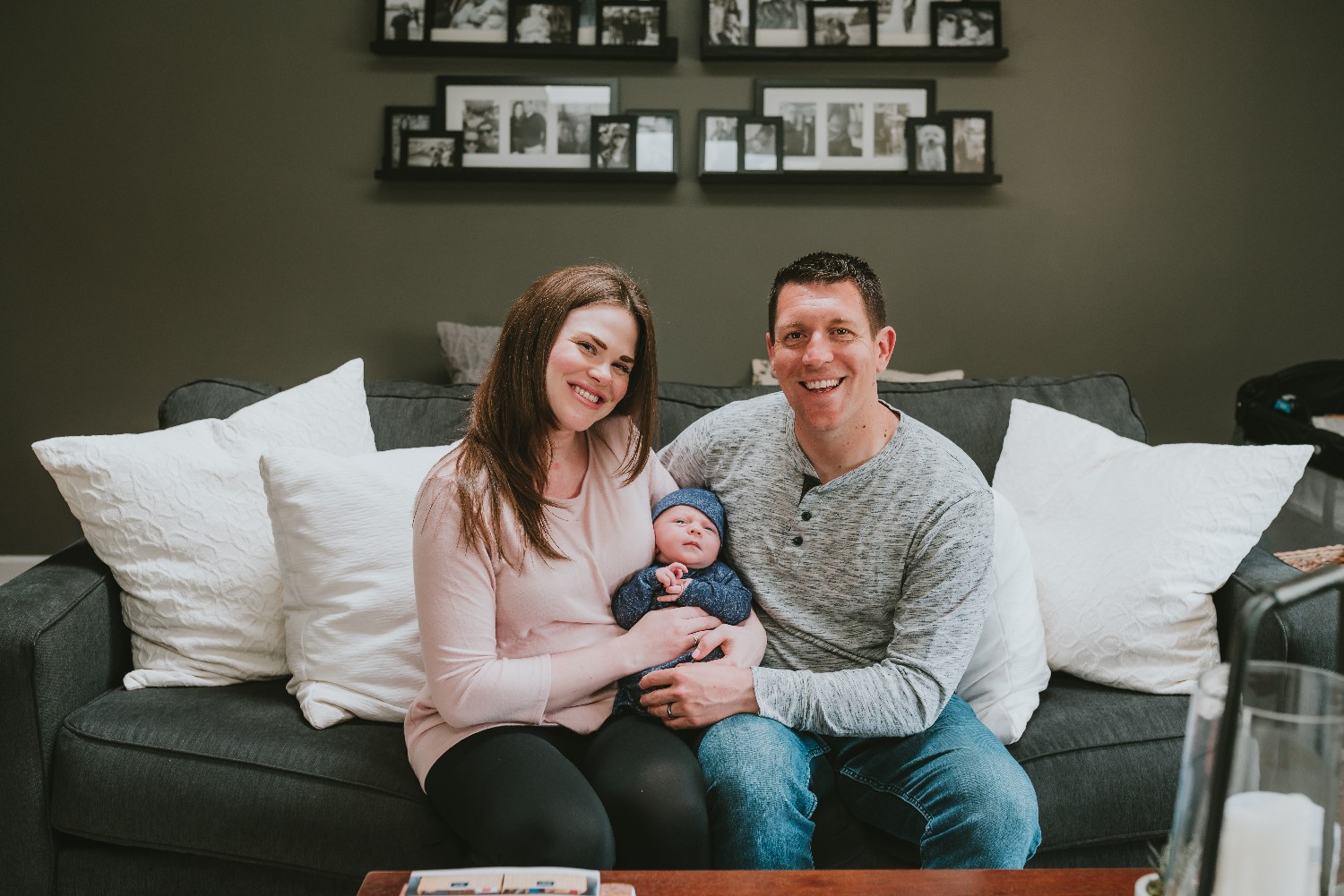 Parents-With-Newborn-On-Couch