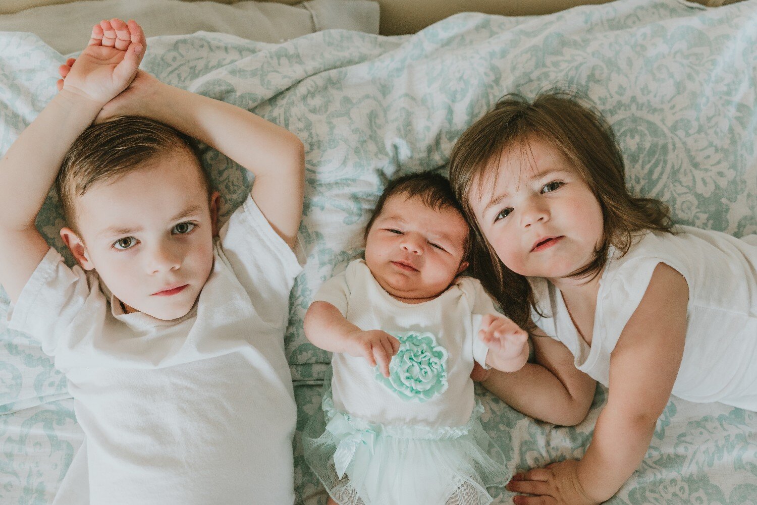 Siblings on a Bed