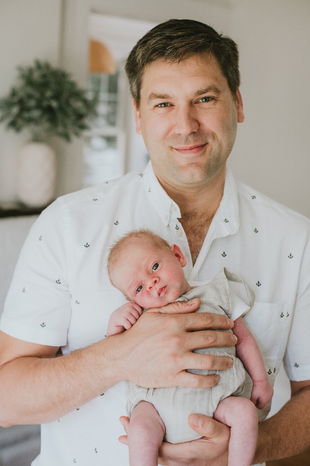 Image-Of-Father-Holding-Newborn