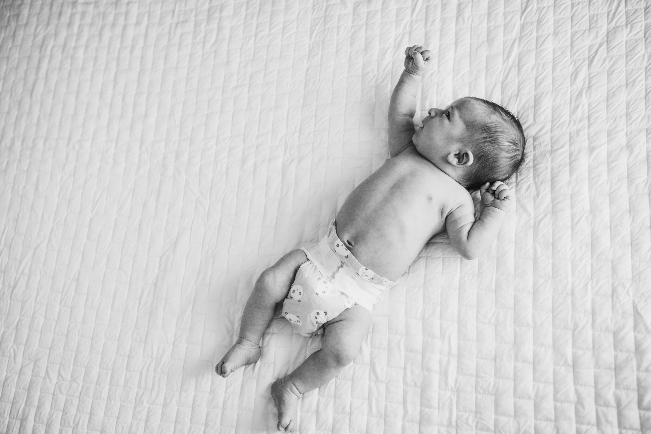 Picture-Of-Newborn-In-Diaper-On-Bed
