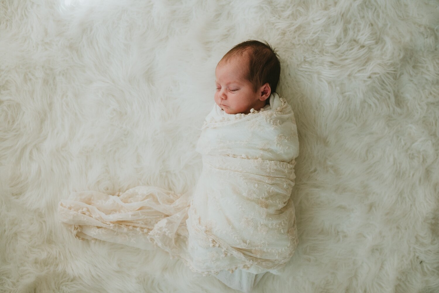 Newborn-On-Fuzzy-Rug-In-The-Nursery