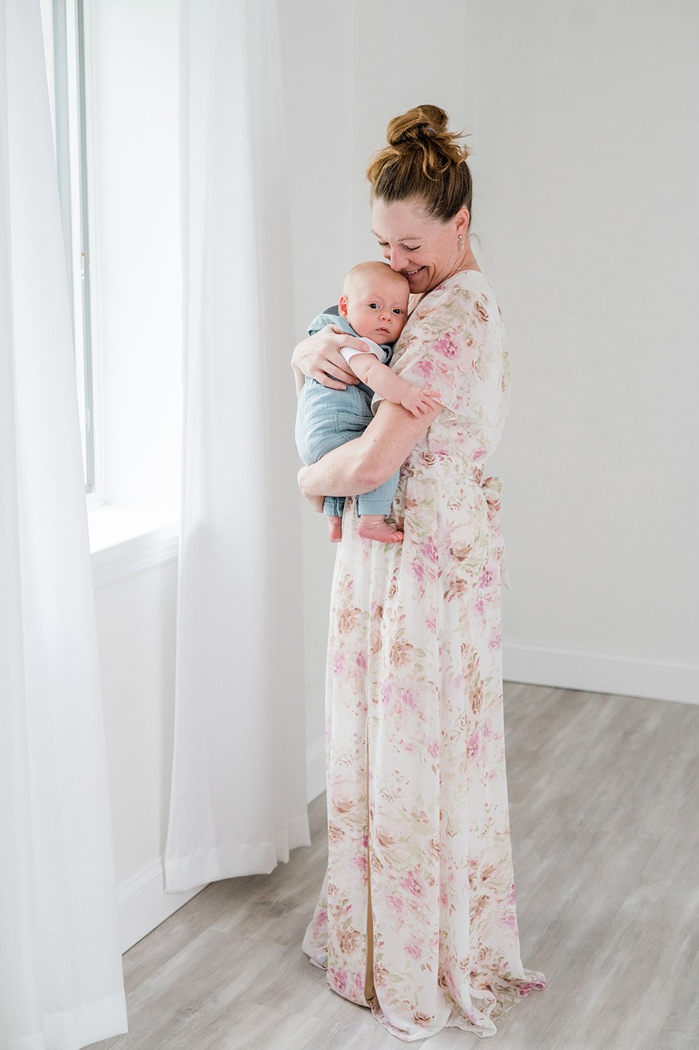Mom-In-Long-Dress-Holding-Baby-Boy-By-Window-Oceanport-NJ-Photography-Studio.jpg
