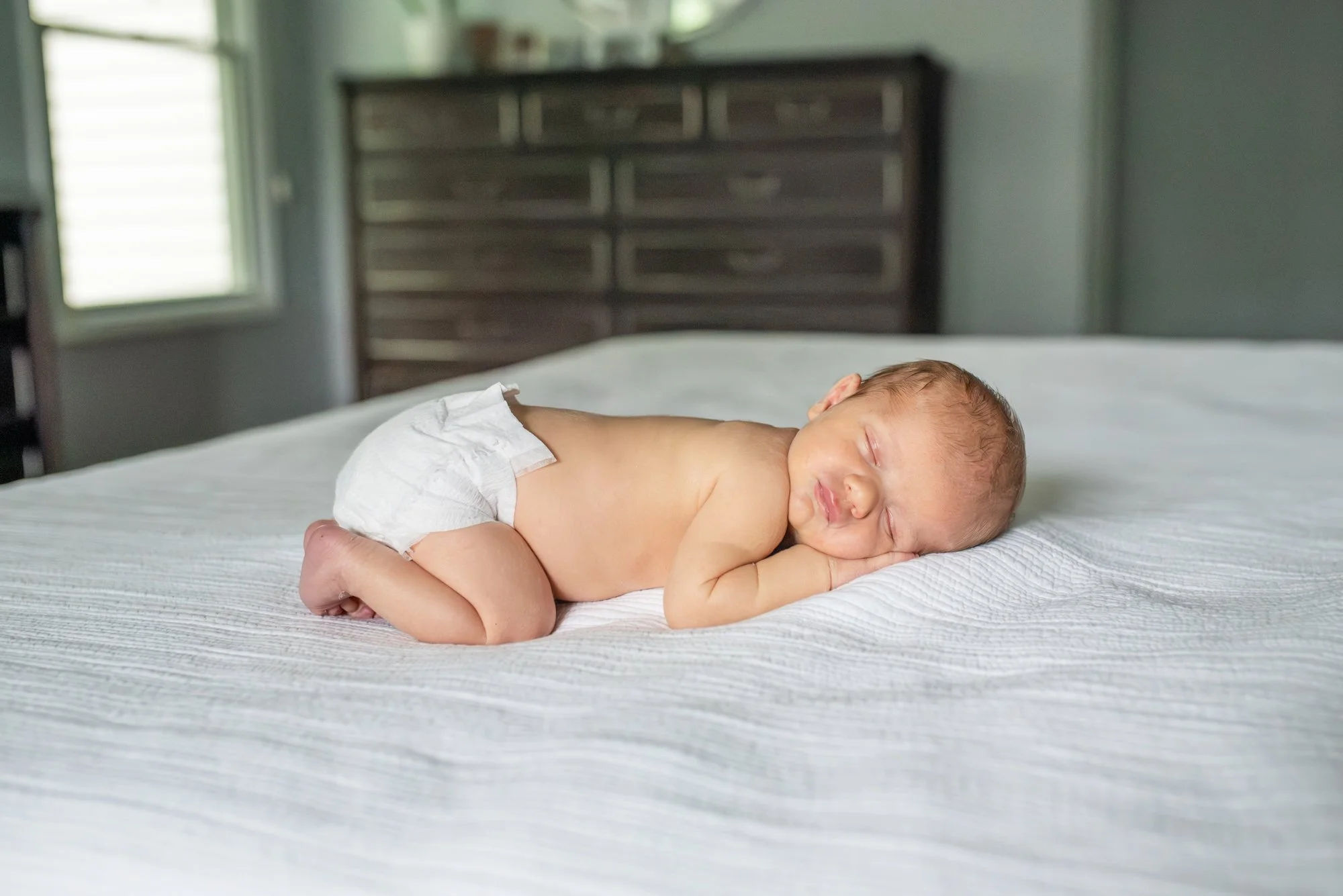 Baby-Boy-On-Belly-On-Bed-In-Home-Newborn-Session-NJ