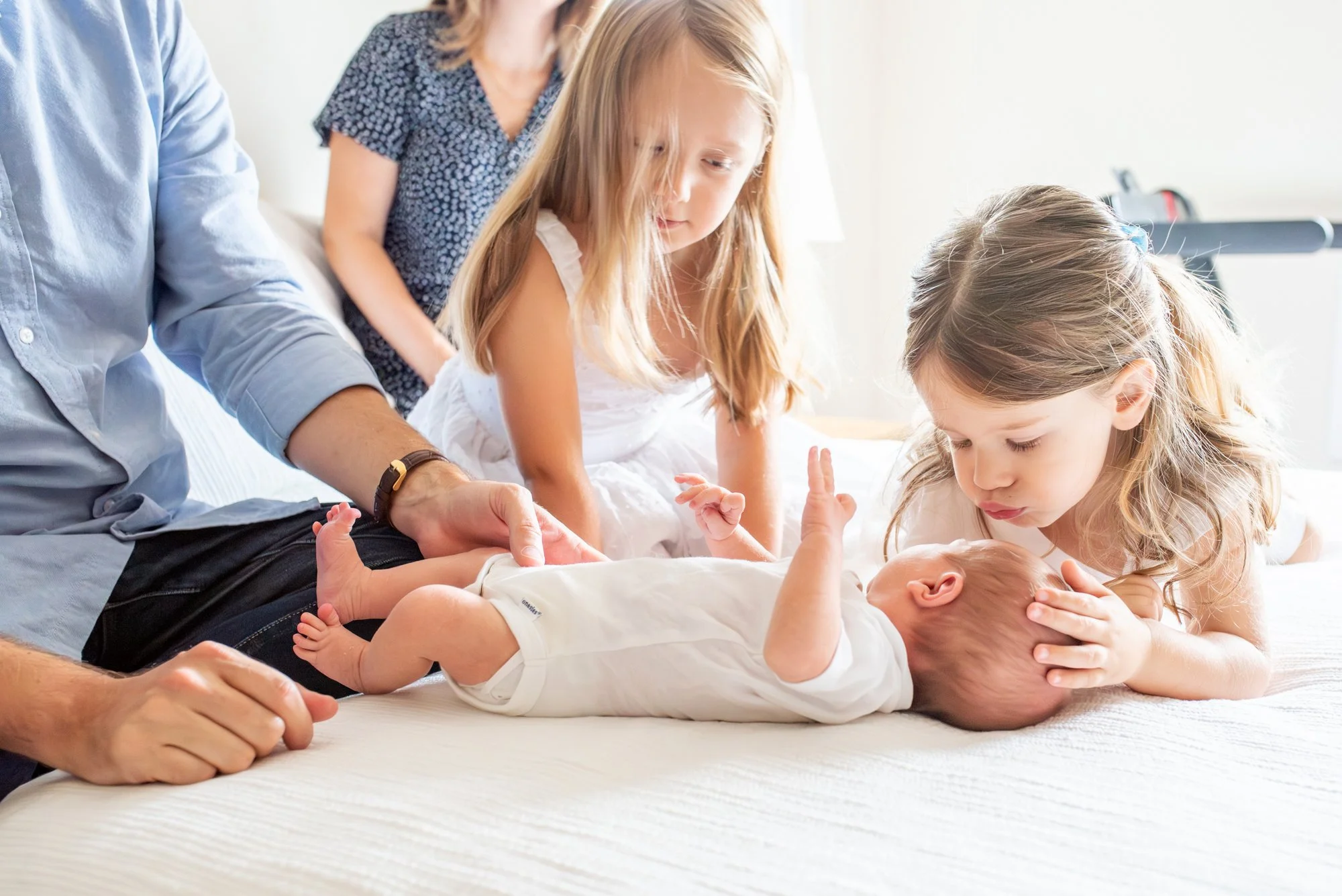 Big-Sister-kissing-Baby-Brother-After-Diaper-Change-In-Home-Newborn-Session-NJ