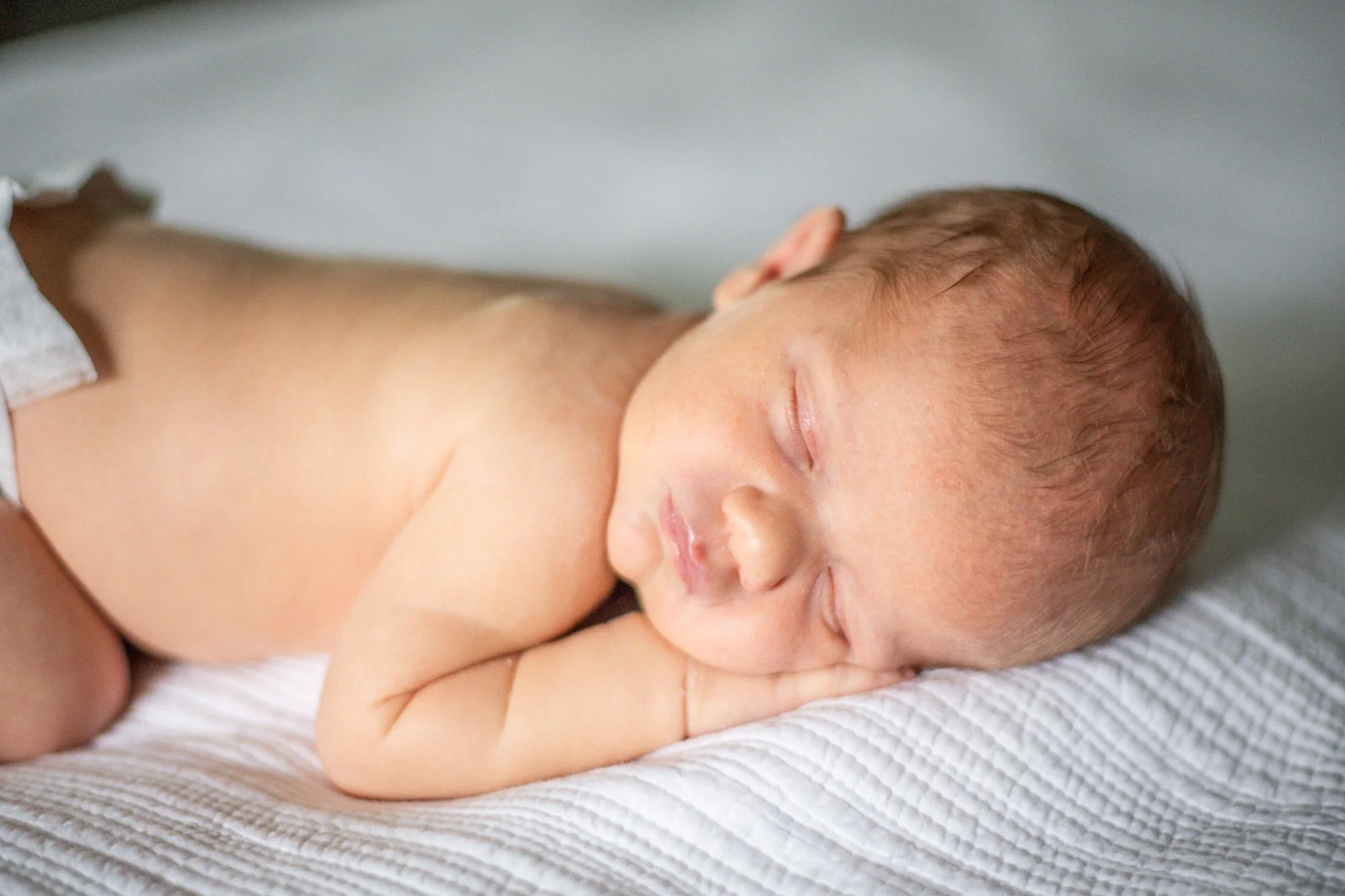 Sleeping-Newborn-Boy-On-Bed-In-Home-Newborn-Session-NJ