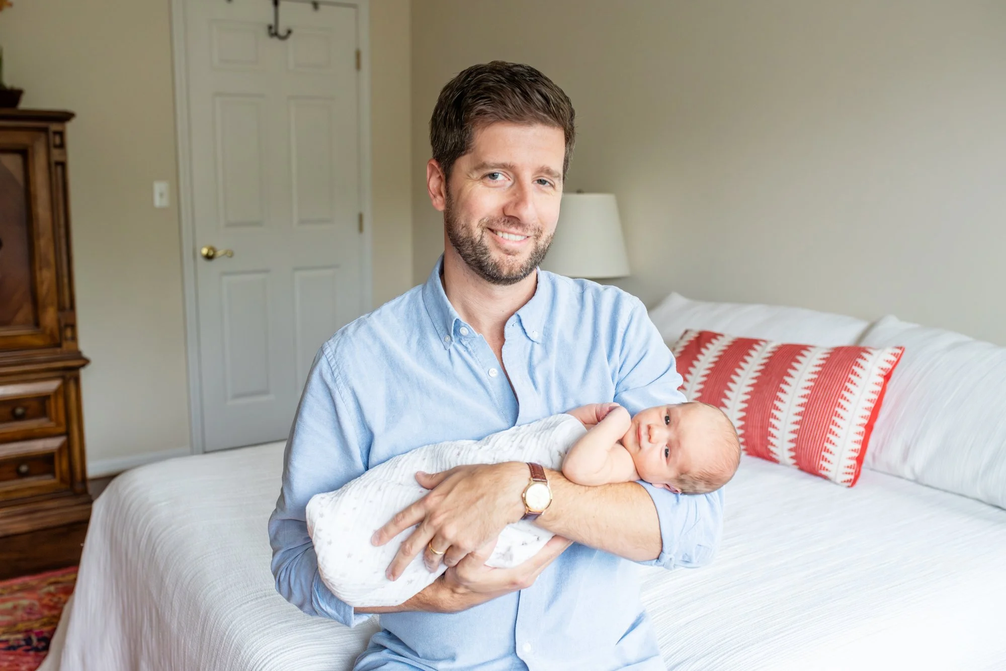 Dad-Looking-At-Camera-Smiling-In-Home-Newborn-Session-NJ