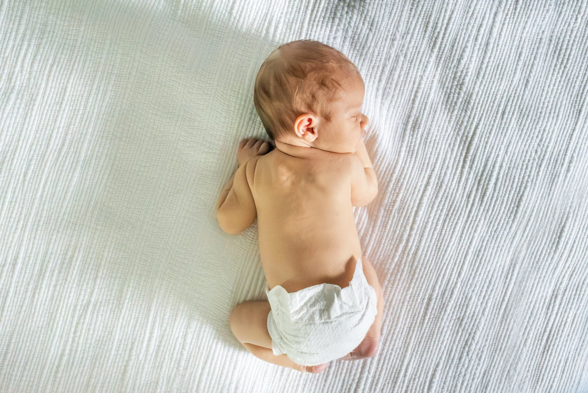 Baby-Boy-On-Bed-On-Tummy-In-Home-Newborn-Session-NJ