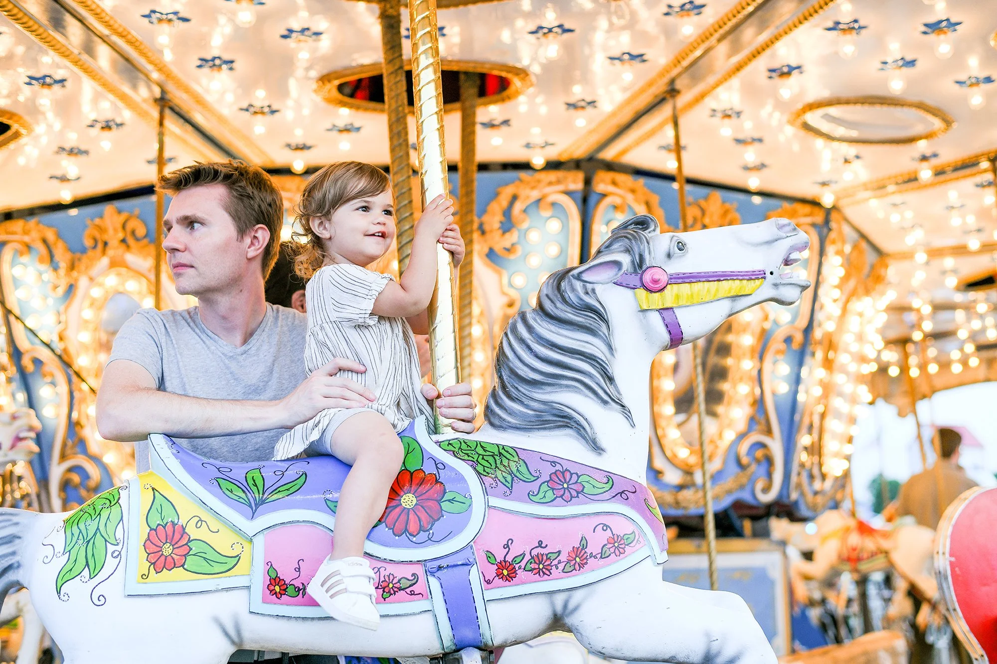 Little Girl and Dad on Carousel at Monmouth County Fair