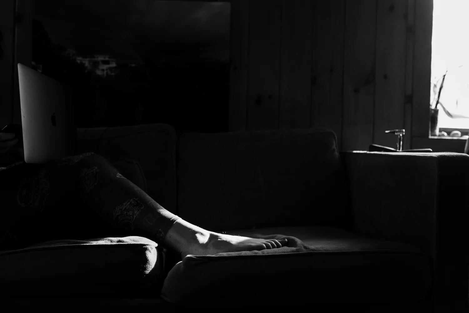 Woman sitting on couch in Wakefield, RI