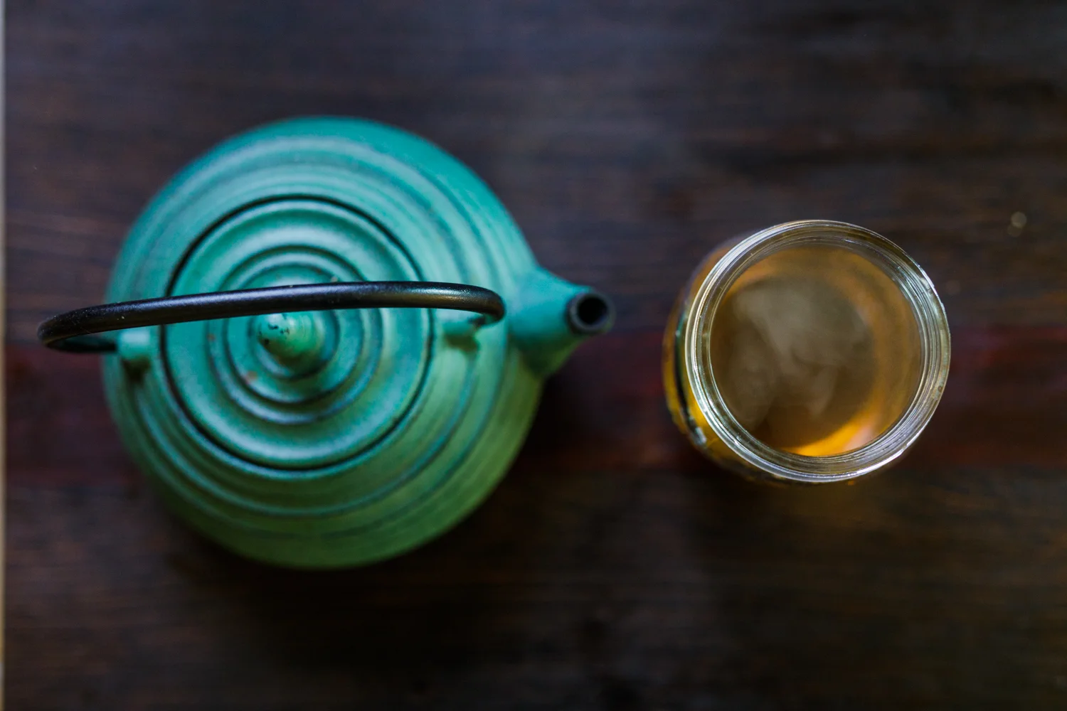 kettle and glass of tea on a table