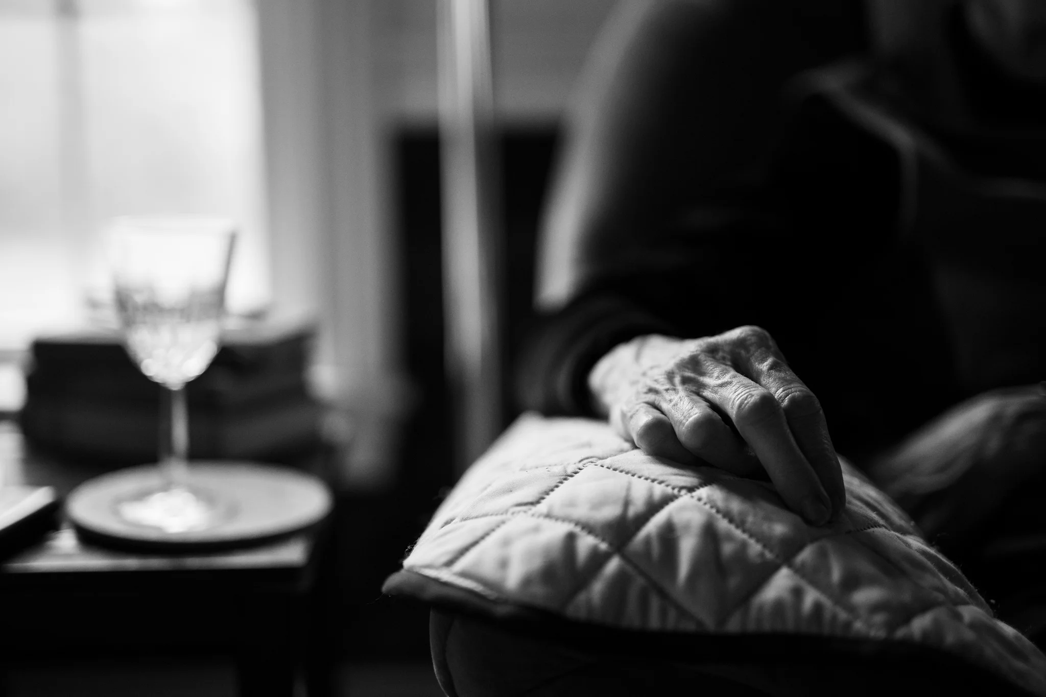 a woman’s hand resting on the arm of a couch
