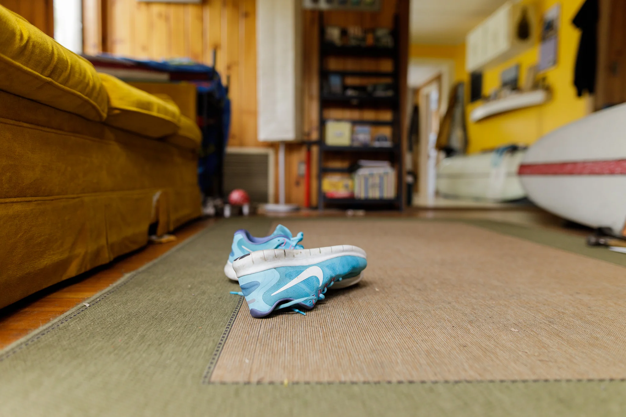 Nike sneakers on a living room rug