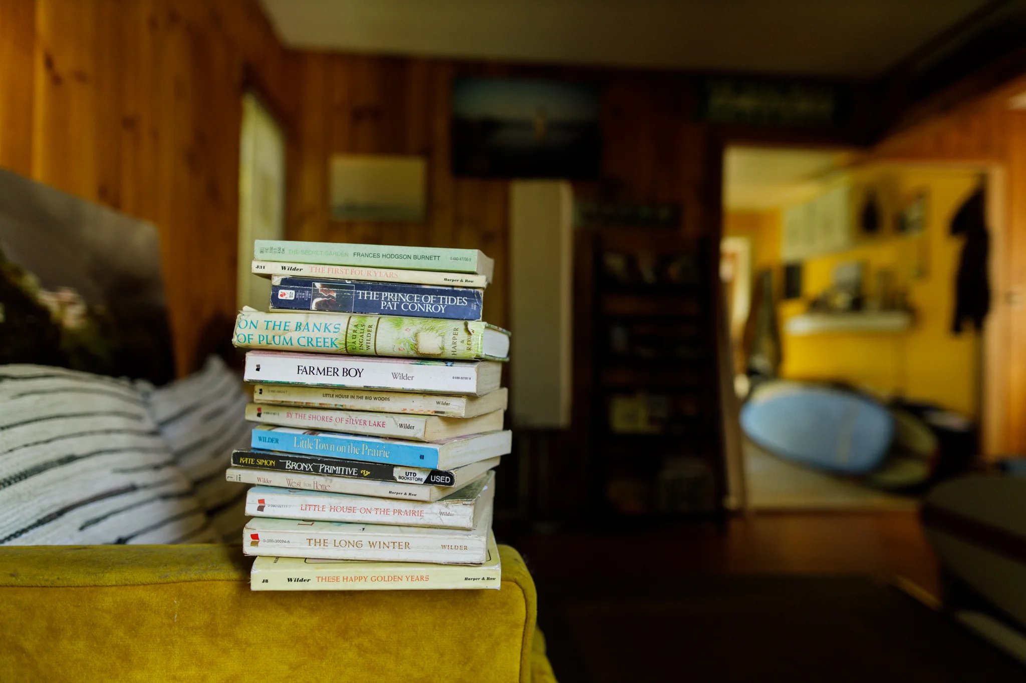 books on the arm of a couch
