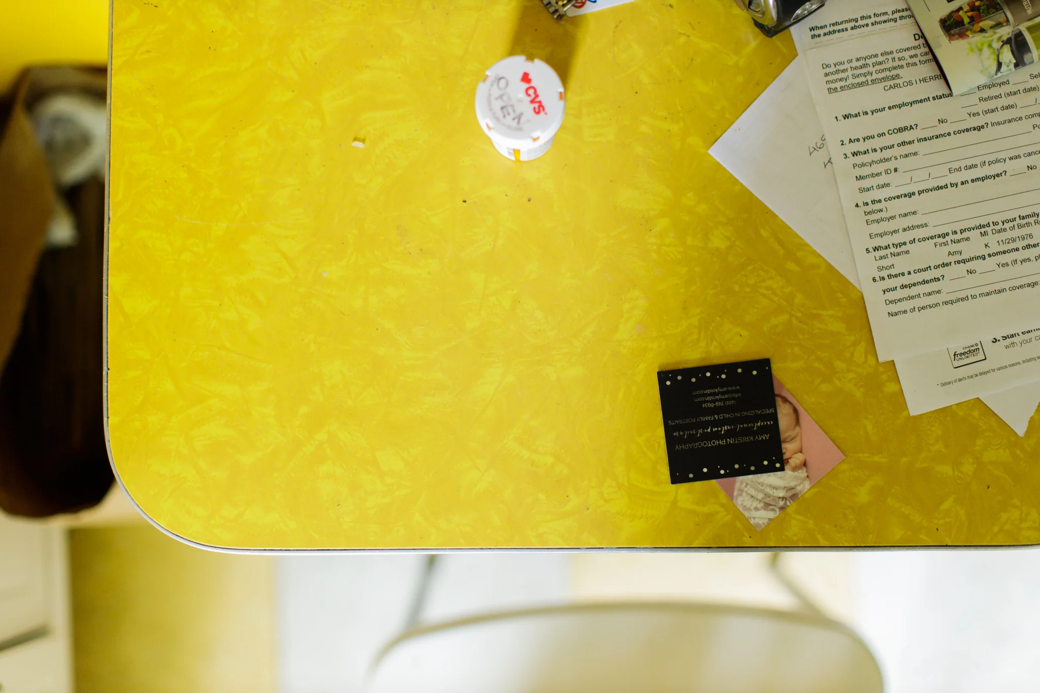 kitchen table with business card and papers on top