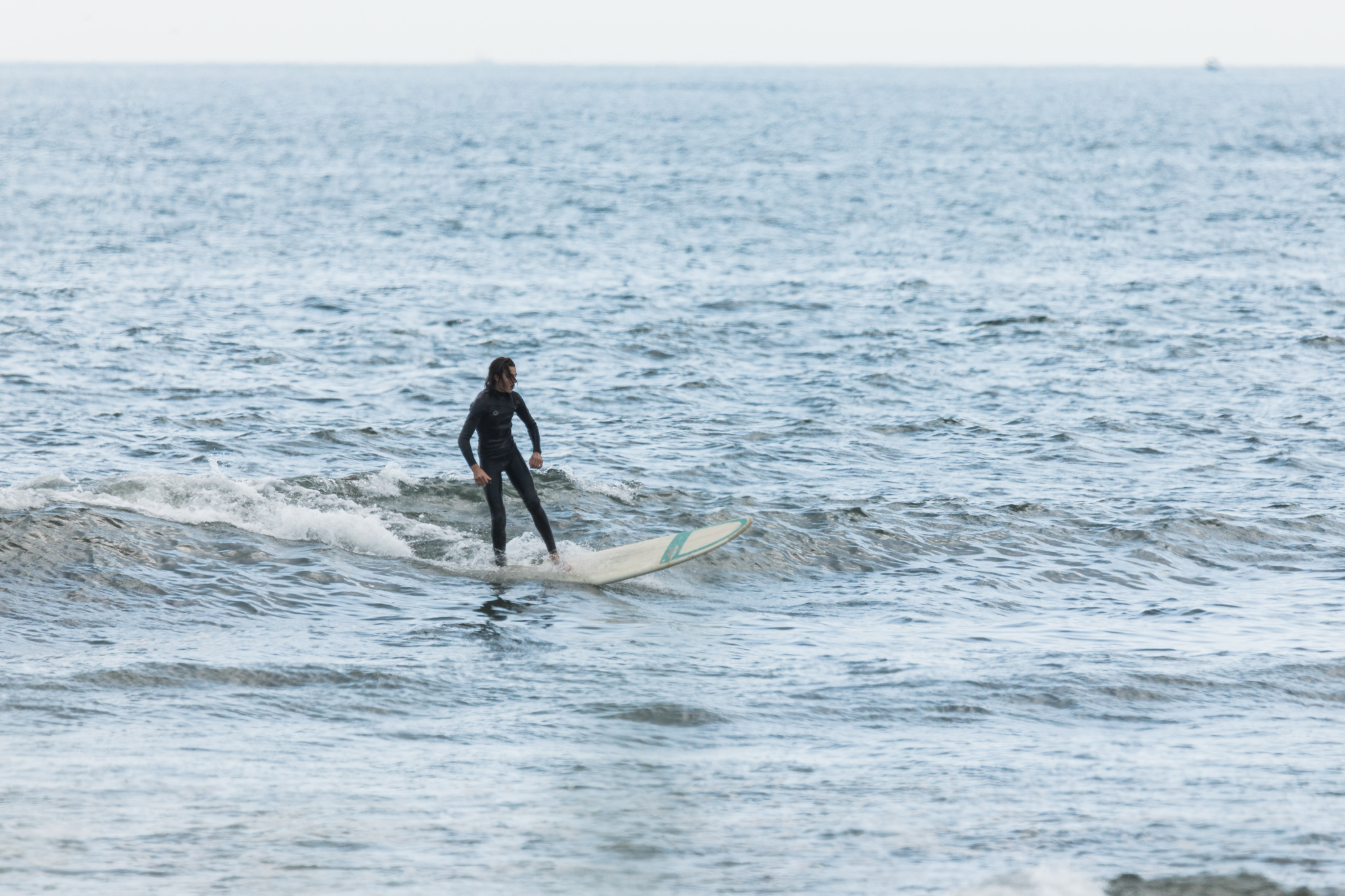 surfer at deep hole in Matunuck, RI