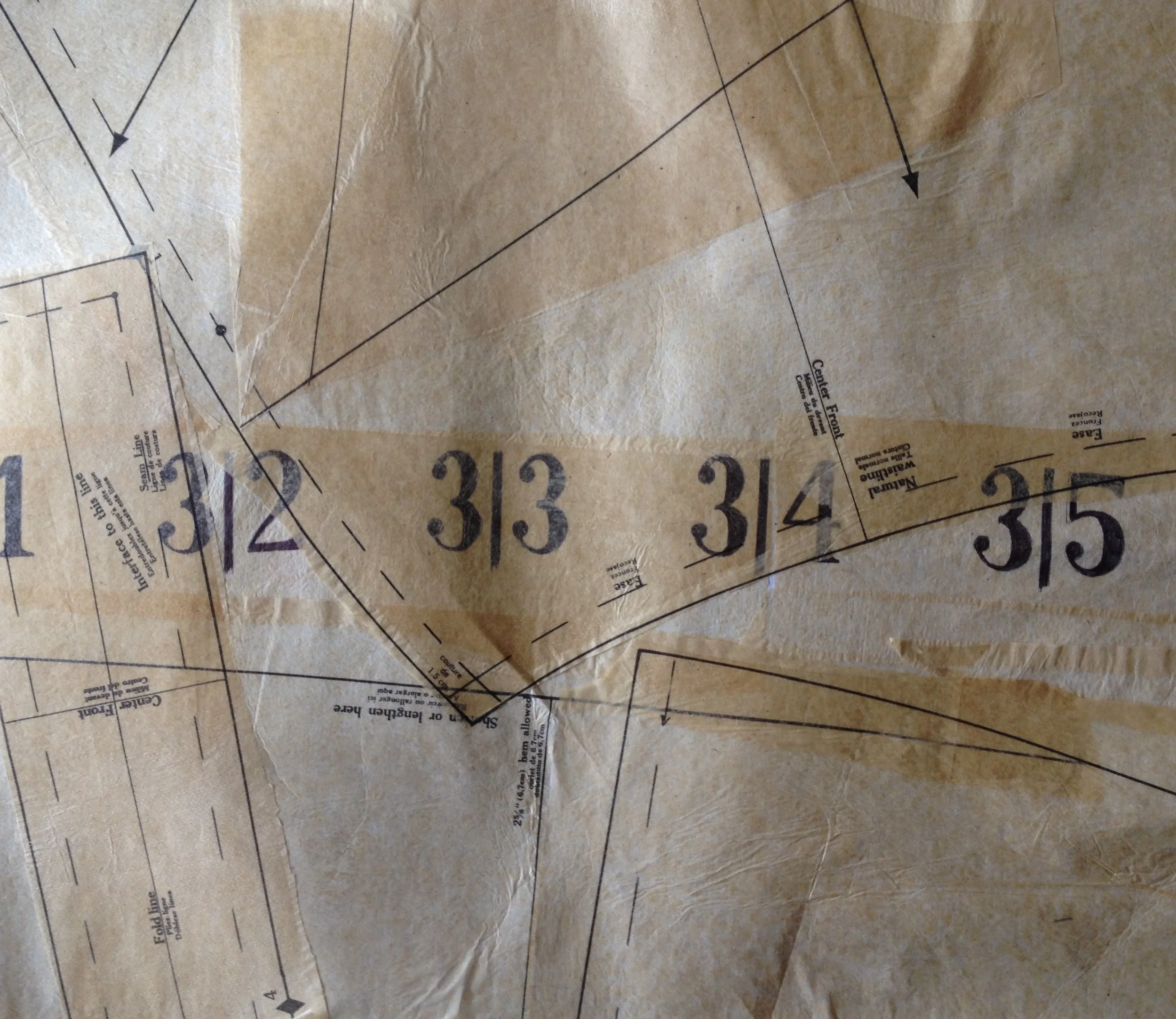with this one, I drew the numbers in ball point pen and then fused the paper to the interfacing, layering more pattern paper on top. There is some potential here, but I am not sure I like how the paper starts to bubble with more and more layers. I think I am going to stretch at least one of these across stretcher bars and place it in a natural frame to see how it compares to the raw edged pieces from Stitch and Rend. 
