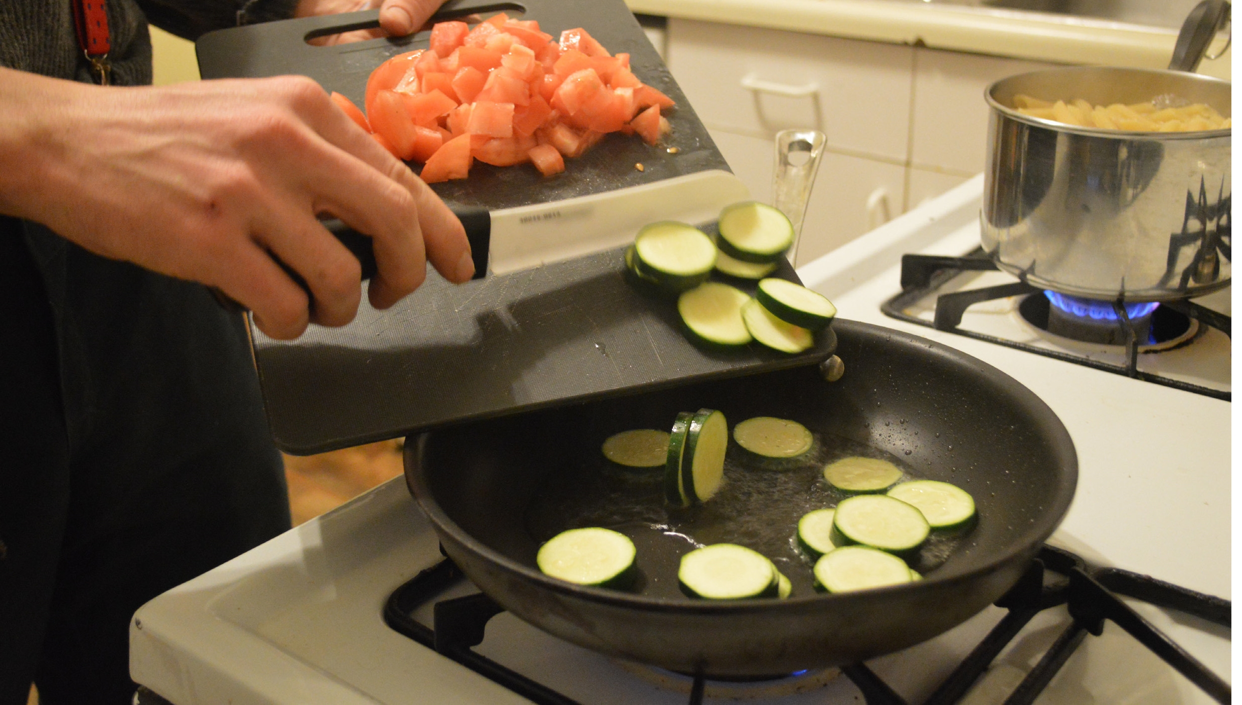 Kitchen 3: An extra cutting board is used to transfer vegetables to the stove. 