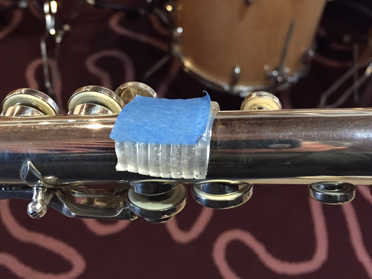 squishy left index finger rest made from a mechanical pencil gel cushion and blue painters' tape.