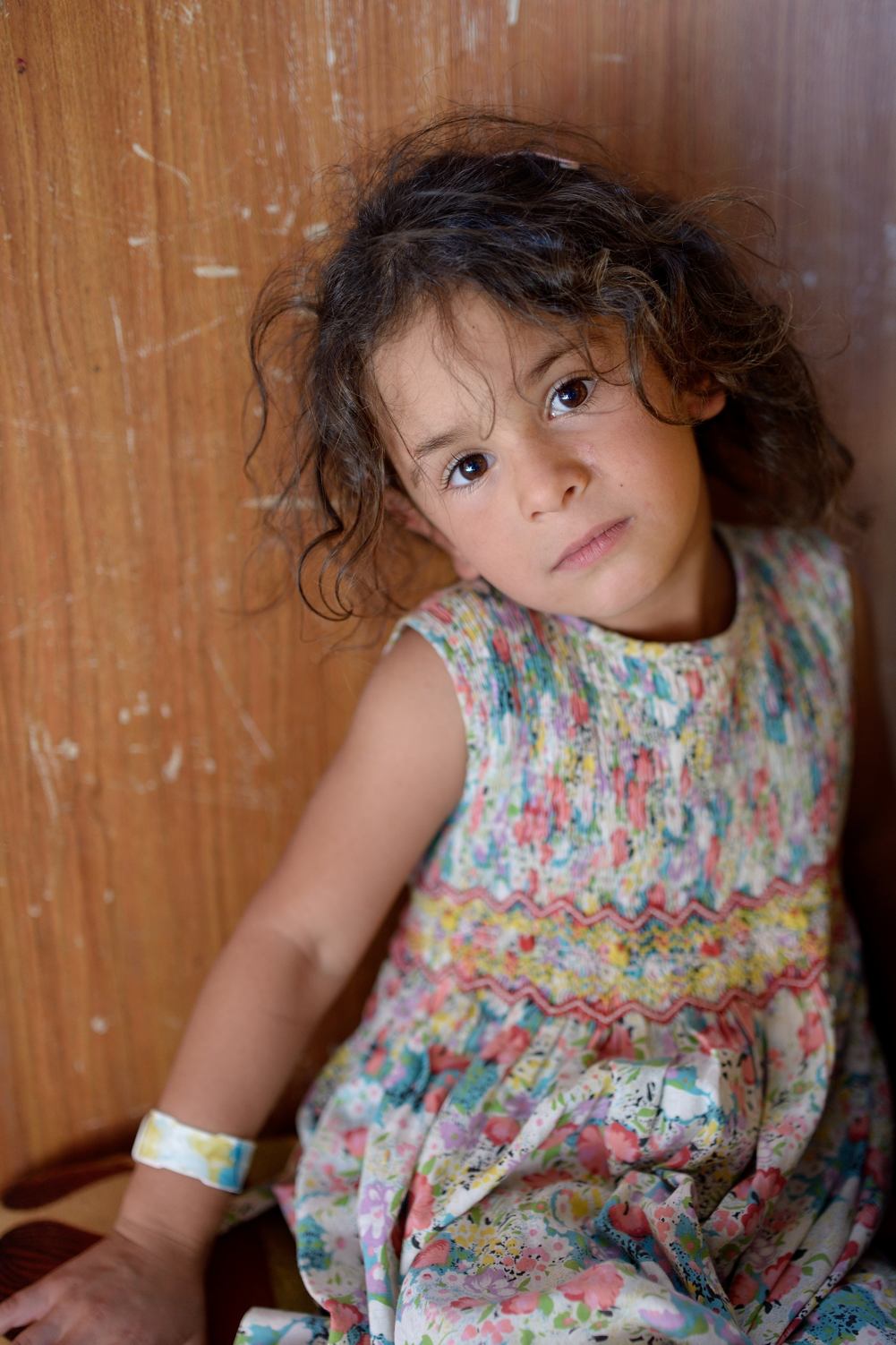 ‘When I returned to my birthplace in Jordan, local villagers said: “Hassan, you left here as a normal man. You return as a refugee.”’ While her father Hassan tells the tragic story of their family, I am watching his little daughter Rachad. She is six. No one shows more clearly the coarse arbitrariness that decides if you’re a refugee or not. She’s a little ballerina, so elegant. The cabin she lives in is really quite ugly and yet it’s also very beautiful. Because I see the meticulous care and attention to detail. In the colourful and banquettes on the walls, in the blue curtains, the games in the cupboard, the pile of cuddly toys on top, the brick wall her father is building around the cabin for the winter. Hassan: ‘I grew up in this Jordanian village, Umm el-Jimal. I swam in the pool beside the ruins of the old town. I went to school here. I had all my friends here. Ten years ago I sold my house to go and see my brother in Syria. It was a good decision, at the wrong moment. ‘Our house was finished, the children were born and then the war broke out. I fled with my brother to Umm el-Jimal. We first rented a house. But the owner needed it himself. So I bought this cabin and built a brick wall around it.' ‘It’s good to wait in my old village until the war is over and not in a camp like many Syrians. My children don’t quarrel here because they don't live in a crowded place like Za'atari. They can play outside, the neighbours know their names. My family is free. We used to own a house. Now we may live in a cabin. But at least it is ours.’ Rachad (6) from Dara’a Umm el-Jimal, Jordan
/* Style Definitions */
table.MsoNormalTable
{mso-style-name:Standaardtabel;
mso-tstyle-rowband-size:0;
mso-tstyle-colband-size:0;
mso-style-noshow:yes;
mso-style-priority:99;
mso-style-parent:"";
mso-padding-alt:0cm 5.4pt 0cm 5.4pt;
mso-para-margin:0cm;
mso-para-margin-bottom:.0001pt;
mso-pagination:widow-orphan;
font-size:10.0pt;
font-family:"Times New Roman","serif";
mso-ansi-language:EN-GB;}
From ' anything out of nothing '
/* Style Definitions */
table.MsoNormalTable
{mso-style-name:Standaardtabel;
mso-tstyle-rowband-size:0;
mso-tstyle-colband-size:0;
mso-style-noshow:yes;
mso-style-priority:99;
mso-style-parent:"";
mso-padding-alt:0cm 5.4pt 0cm 5.4pt;
mso-para-margin:0cm;
mso-para-margin-bottom:.0001pt;
mso-pagination:widow-orphan;
font-size:10.0pt;
font-family:"Times New Roman","serif";
mso-ansi-language:EN-GB;}