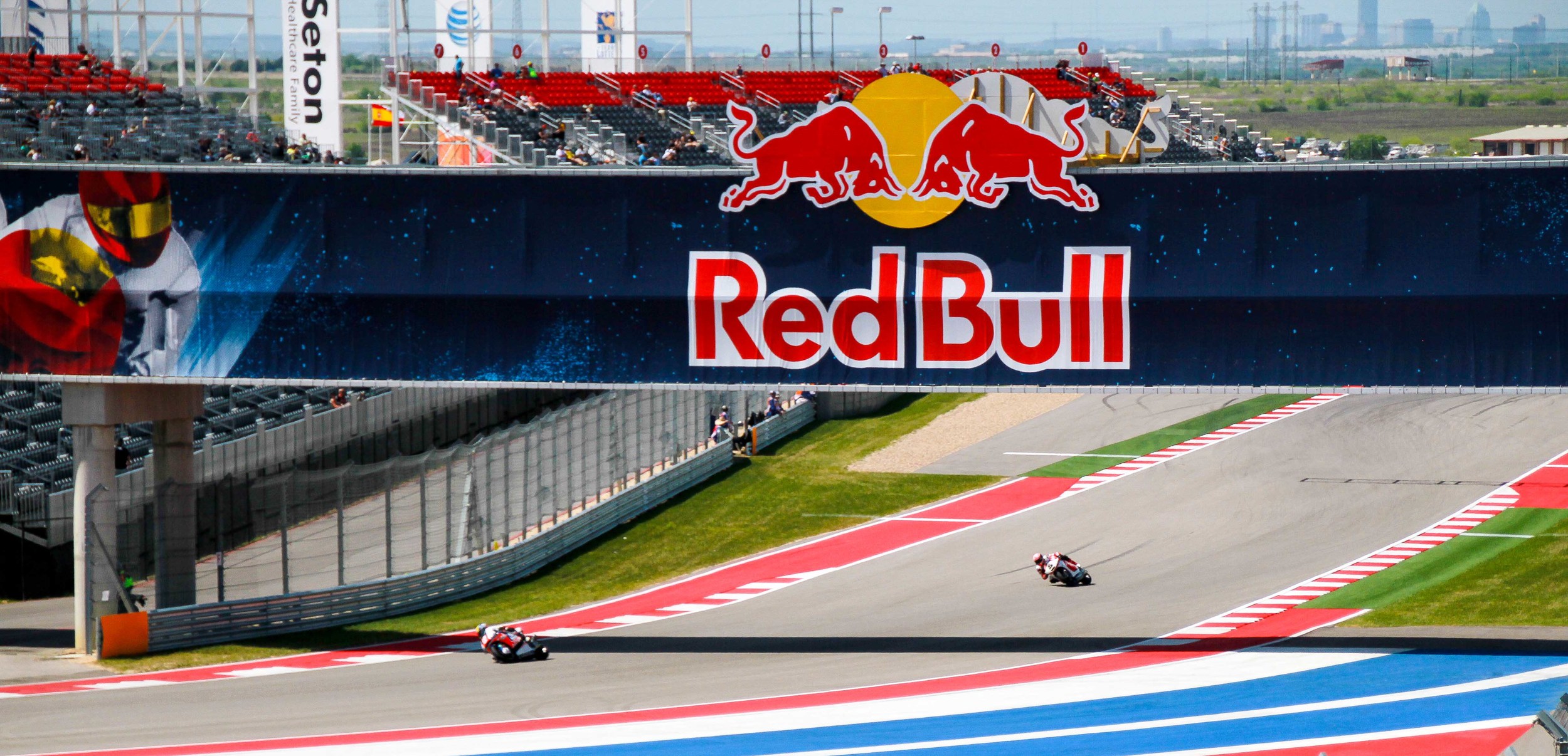  Moto2 Riders passing under the pedestrian bridge by Turn 16 at the Circuit of the Americas. 