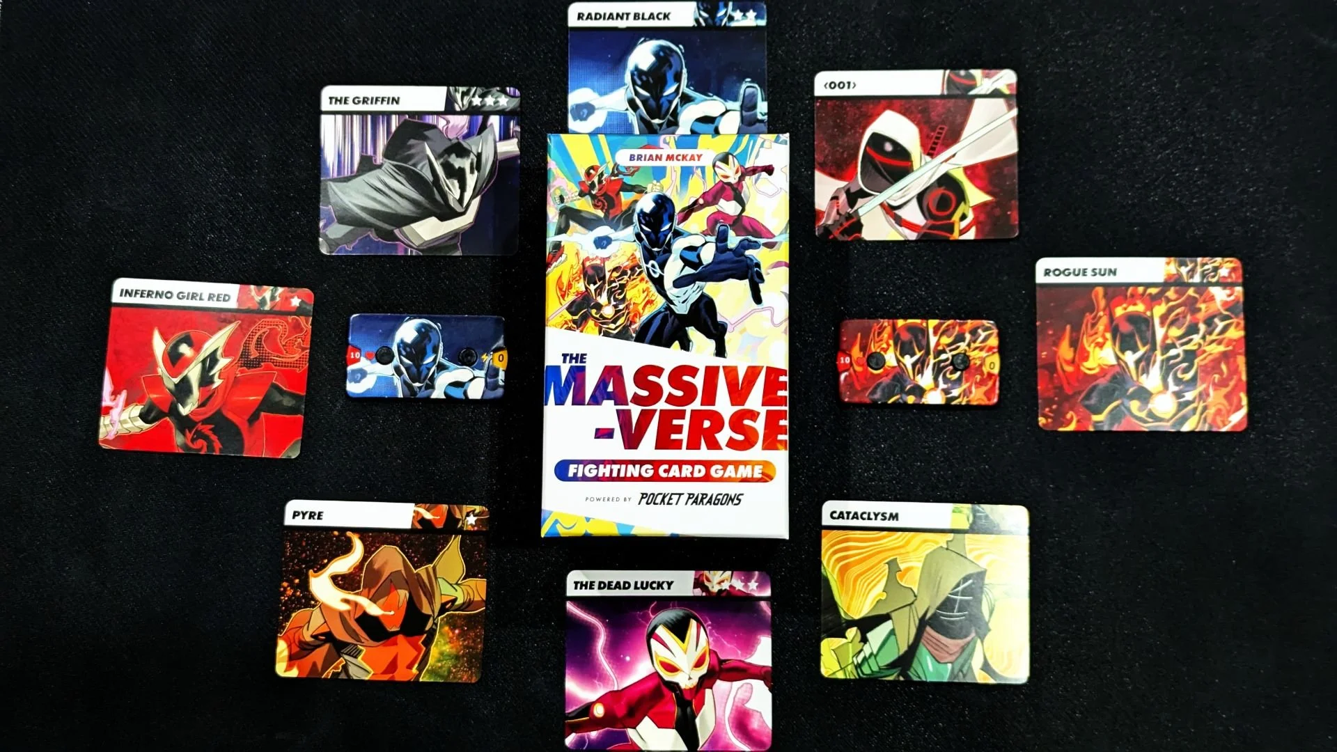 Picture cards of various Massive-Verse characters surround a box for the Massive-Verse Fighting Card Game.