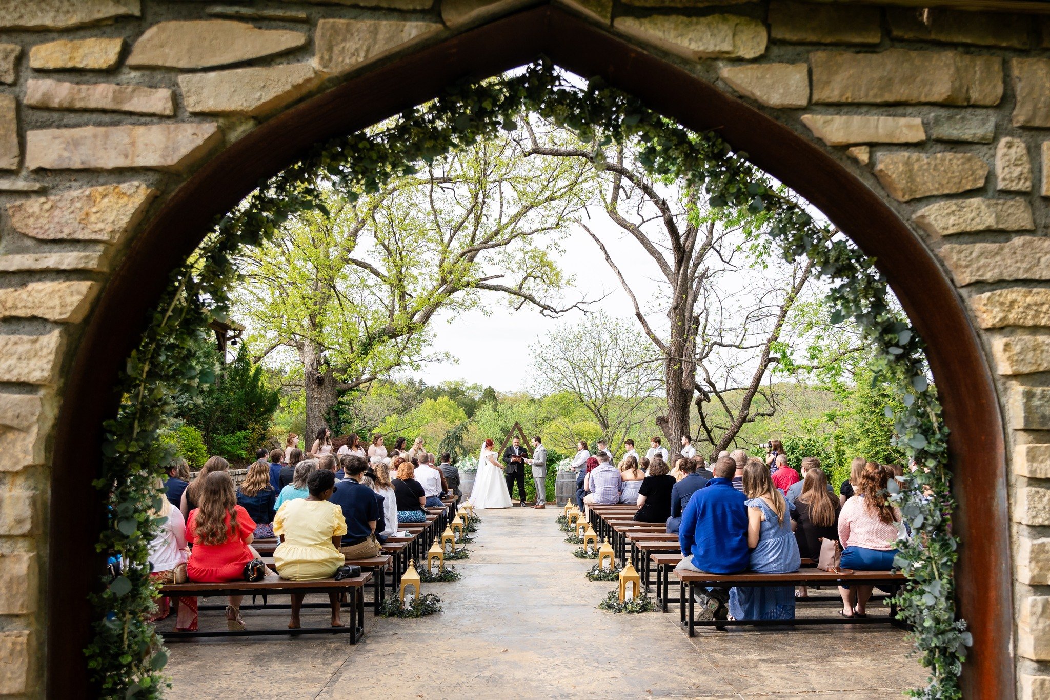 This is what wedding ceremony dreams are made of: stone archways, wooden doors, and a tree-filled backdrop for those &ldquo;I do&rdquo; moments. 😍🌳

Wedding Day Vendors👇
Photographer: @GGStudiosByKristy
DJ + Photo Booth: @Big_Show_Productions
Cate