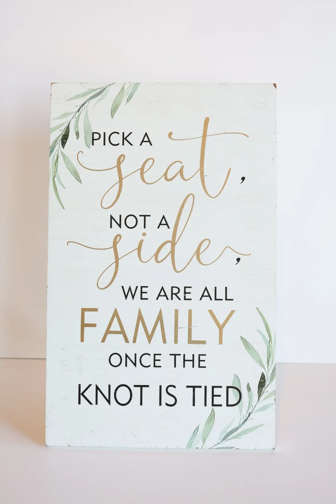 White Pick a Seat Sign with Black and Gold Lettering