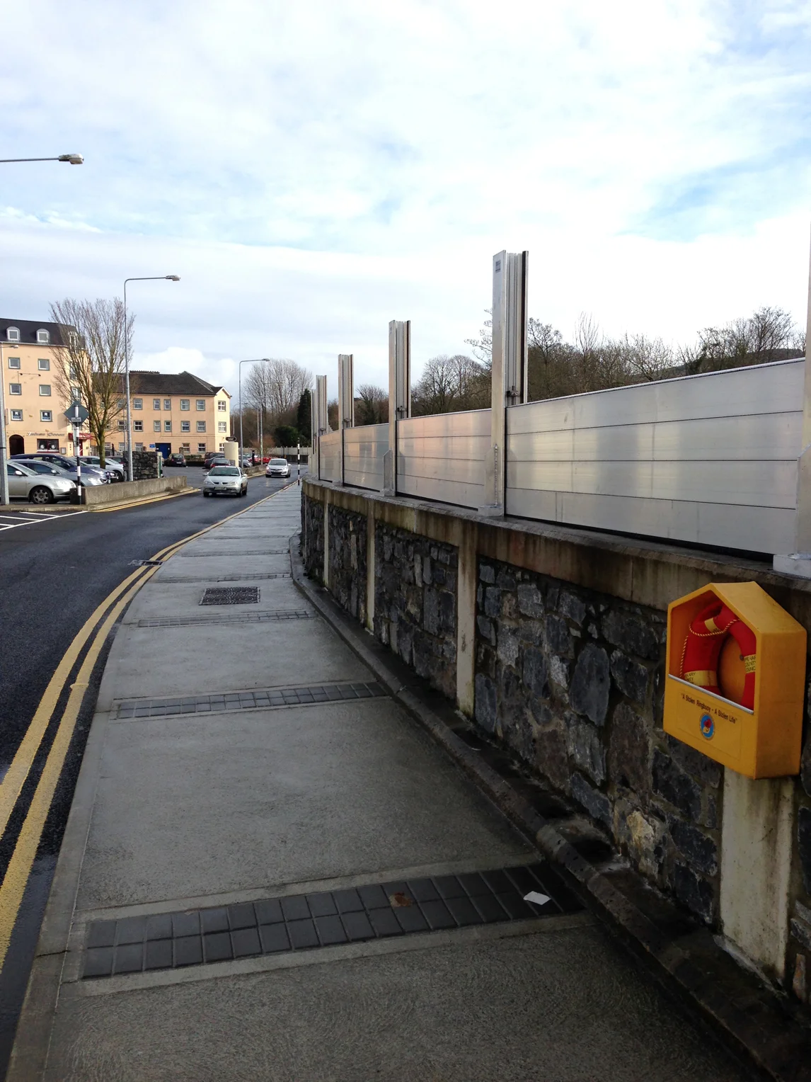 Demountable flood defences partially in place on quay wall along River Suir