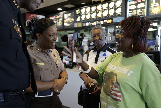 Dorothy Smith, right, talks with Miami-Dade county police officer Delma Noel-Pratt, left, during a Coffee with a Cop event at a local McDonald’s on April 27, 2016, in Miami Gardens, Florida. LYNNE SLADKY/AP
