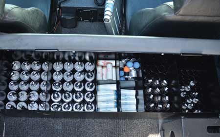 Key Steel fabricated and installed a locking bench seat directly behind the driver and passenger seat, with storage on the inside. The bench seat, which could seat two additional officers, is hinged toward the front of the vehicle, lifting to reveal space divided into eight compartments. Four of the compartments were specially designed with circular steel rings to securely hold various munitions.